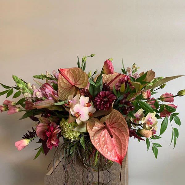 Passion Passion - This gorgeous arrangement consists of a lush mix of seasonal blooms featuring gorgeous anthurium and local orchids when available. PLEASE NOTE: Flower colors and varieties will vary due to availability but the over all aesthetic of the arrangement will stay the same. Our designers always select the freshest blooms for your arrangement.