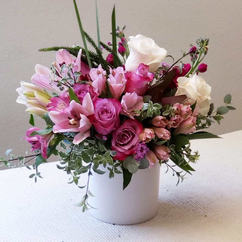 Spectrum Elegance - Spectrum Elegance Bouquet presents a delicate blend of grace and beauty, featuring a soft palette of pinks and whites.   Pink roses and alstroemeria are accented with white roses and complemented by subtle greenery, all arranged in a classic white vase.  Approximately 16&quot; H x 16&quot; W. Get your hands on this floral arrangement today!