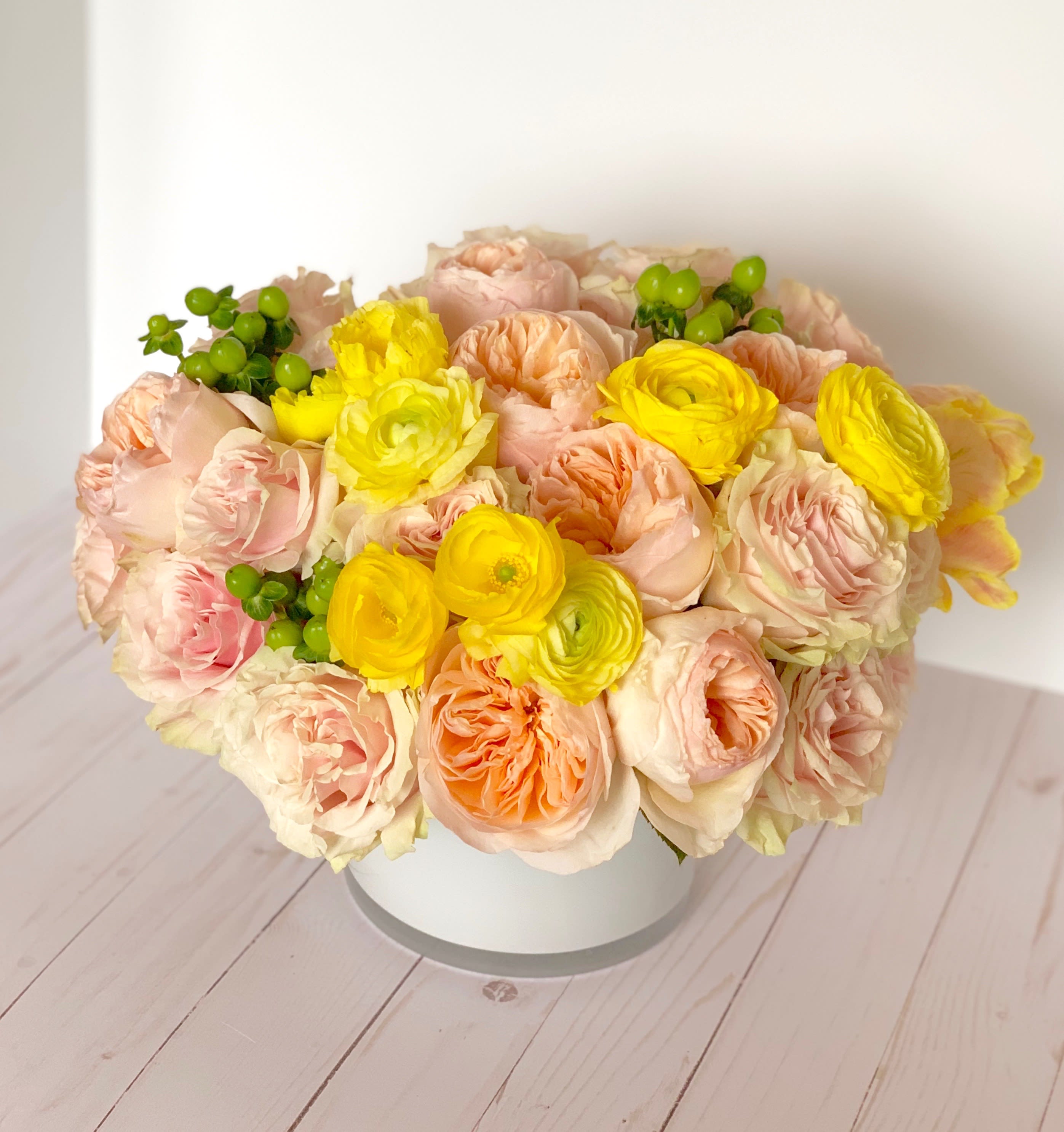 Spring Love - An eye-catching display of beautiful mixed floral in soft tones of blush, peach and yellow. 