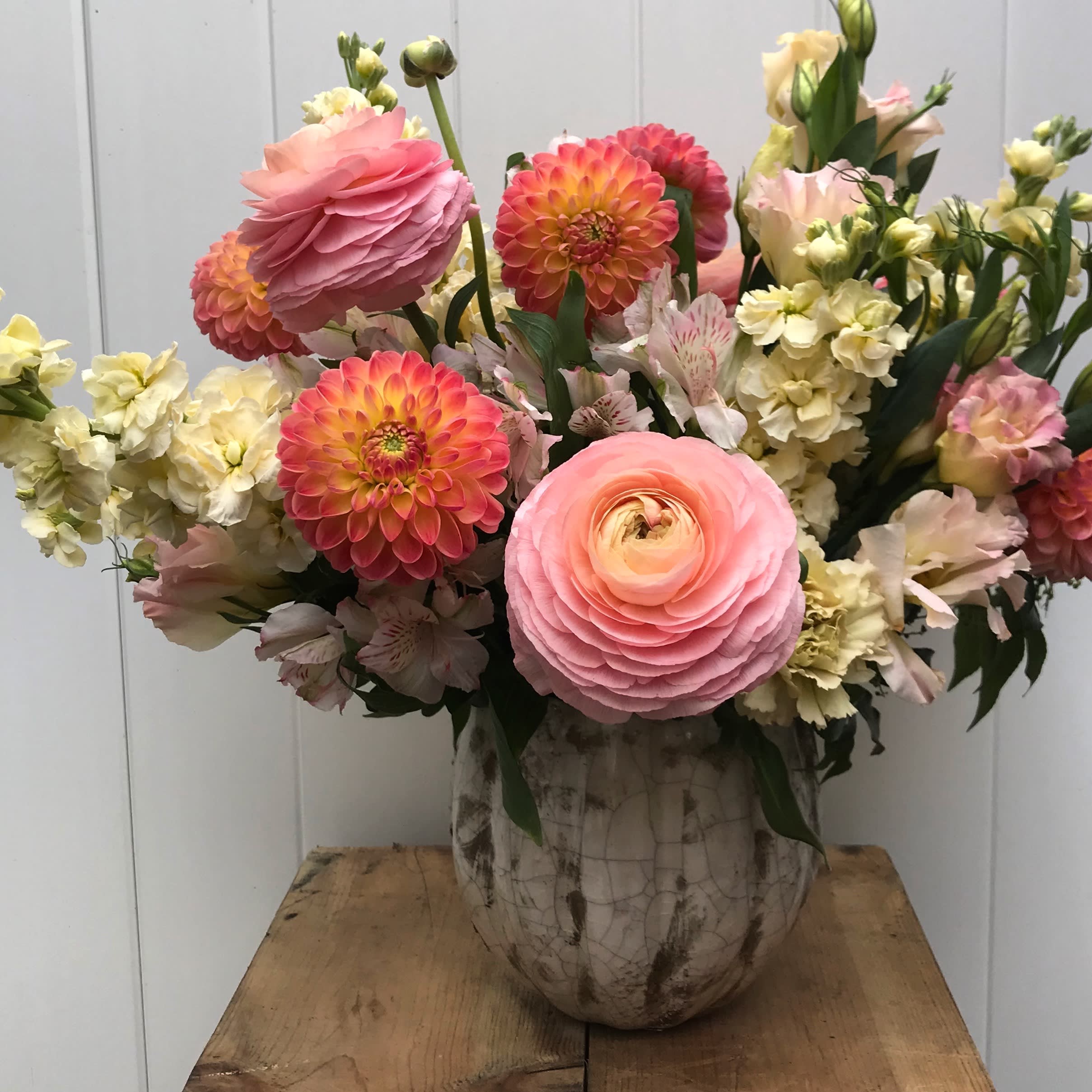 Voila! - Make her say WOW!!  This arrangement is a complete game changer and is all about showing of those gigantic dutch Ranunculus.  Please call to confirm availability as these are rare.  Arrangement color tone subject to change (we design around the ranunculus).  