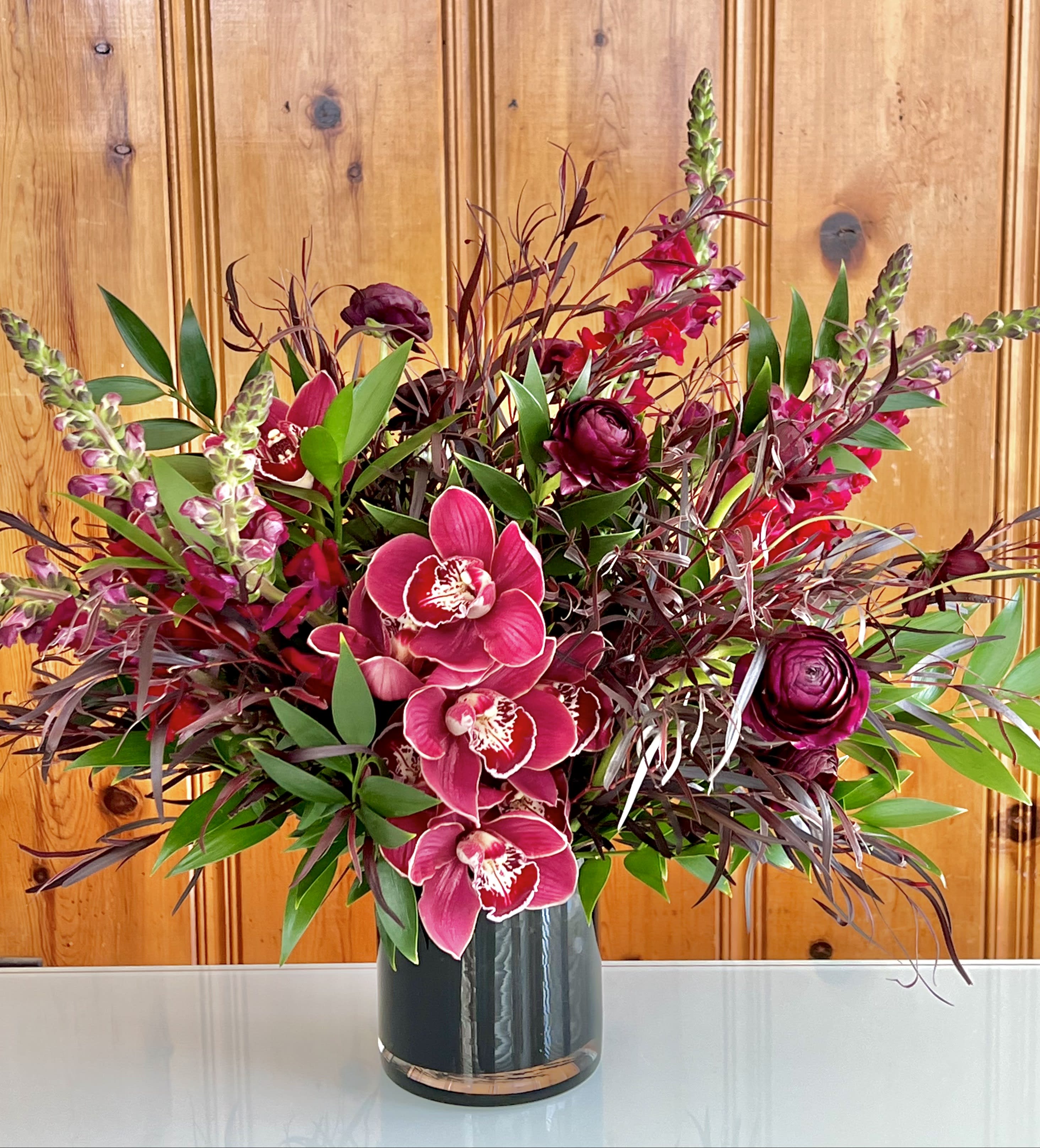 Oh My Goth! - Unique and dramatic arrangement features richly colored maroon blooms! 