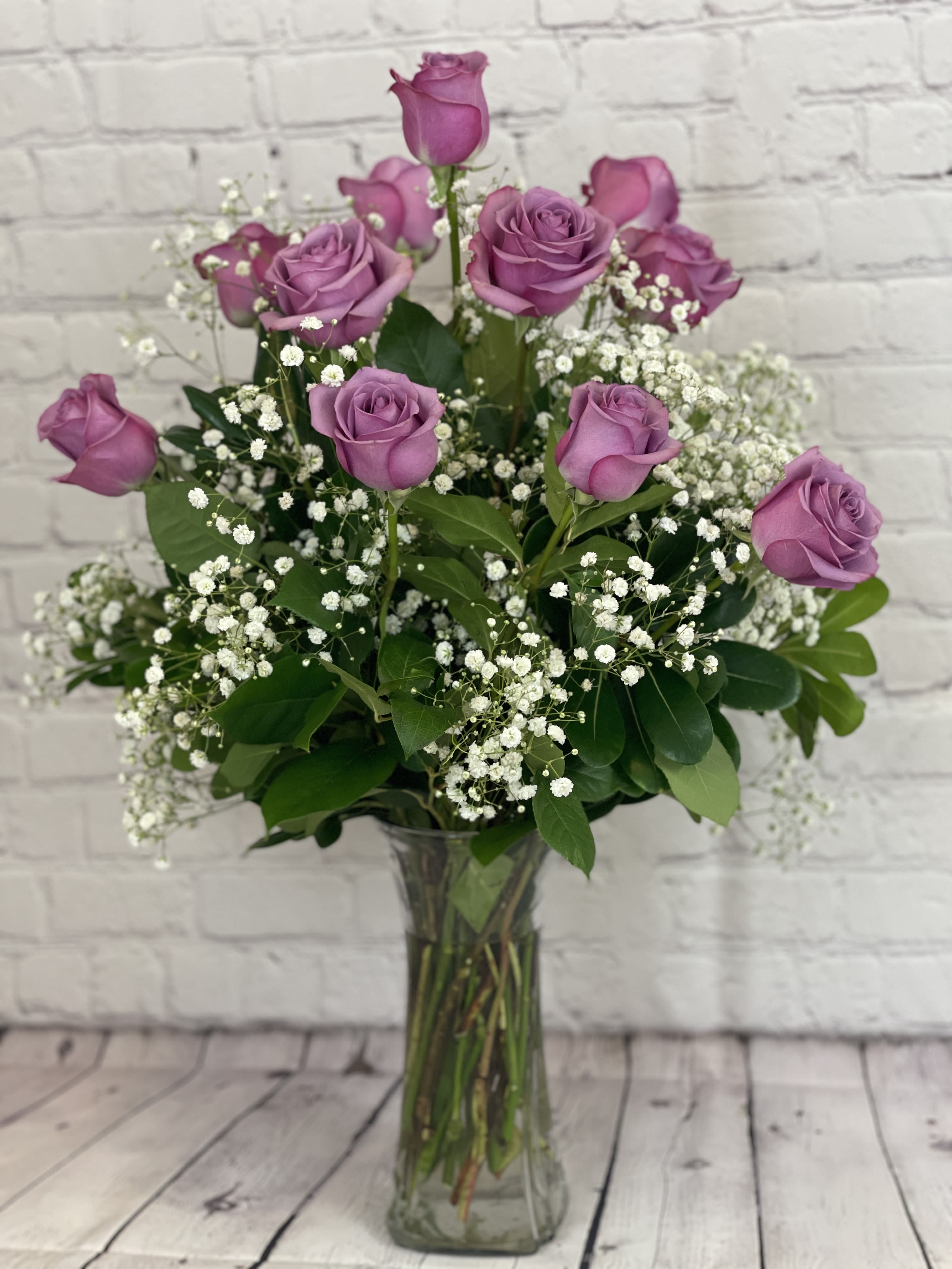 1 dozen Lavender Roses by Blooming Canyon  - Envelop your loved ones in the delicate charm of a dozen lavender roses, a perfect symbol of love at first sight, elegance, and enchantment. The soft, captivating hue of lavender evokes feelings of admiration and mystery, making it an ideal choice for romantic gestures, anniversaries, or special milestones. Each rose is carefully selected for its beauty and freshness, ensuring your bouquet arrives as a breathtaking gift.  Elegantly arranged and thoughtfully delivered by Blooming Canyon, these lavender roses are sure to leave a lasting impression, adding a touch of sophistication and grace to any occasion.  