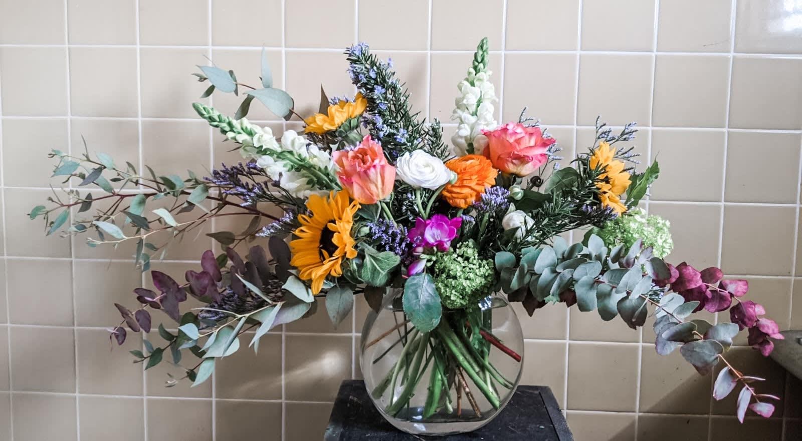 Grounding Blooms - A perfect arrangement for any Down to Earth person! An assortment of season blooms with various textures and colors. 