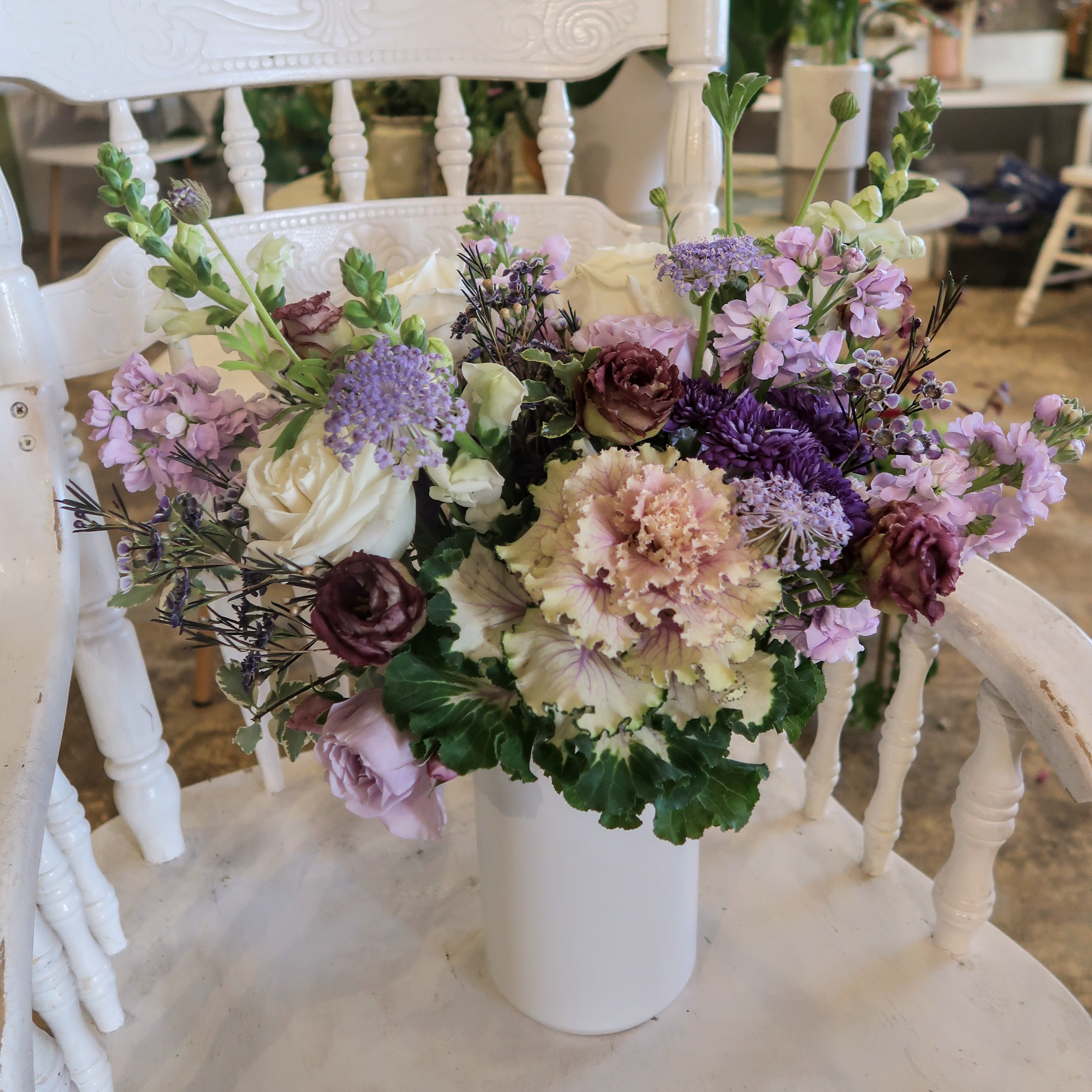 Love In Violet - A purple lover's dream! This arrangement comes with assorted flowers in hues of violet and in a matte white ceramic vase. 