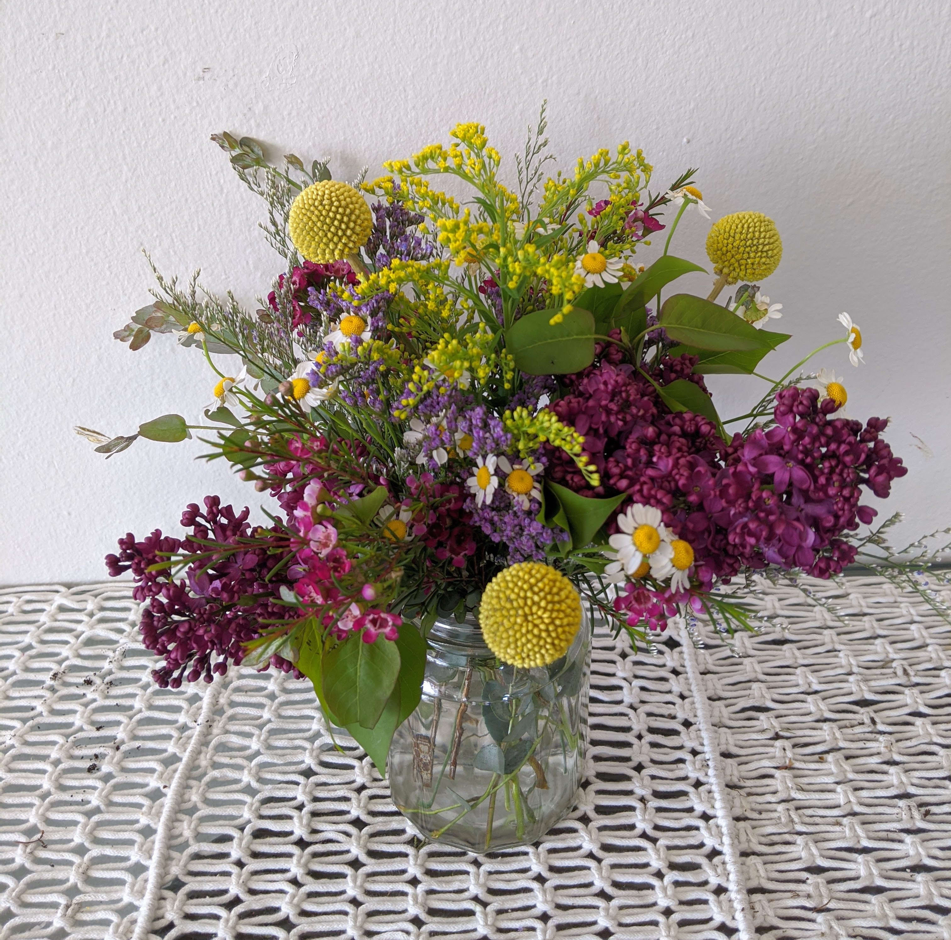 Stay Wild Stay Wild - An assortment of wildflower-y fillers and blooms in a jar style vase is perfect for those who enjoy a nice walk in their garden.