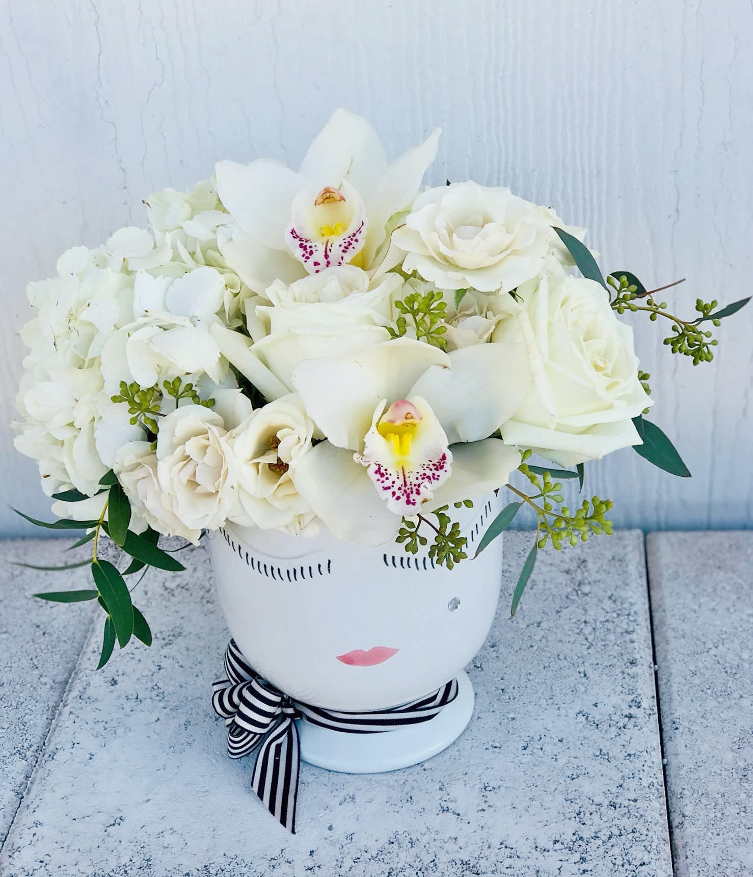 Simply chic Celfie - Classic chic all white arrangement of roses, hydrangea and orchids, beautifully placed in a Celfie vase.  Upgrades add more flowers to the same arrangement.