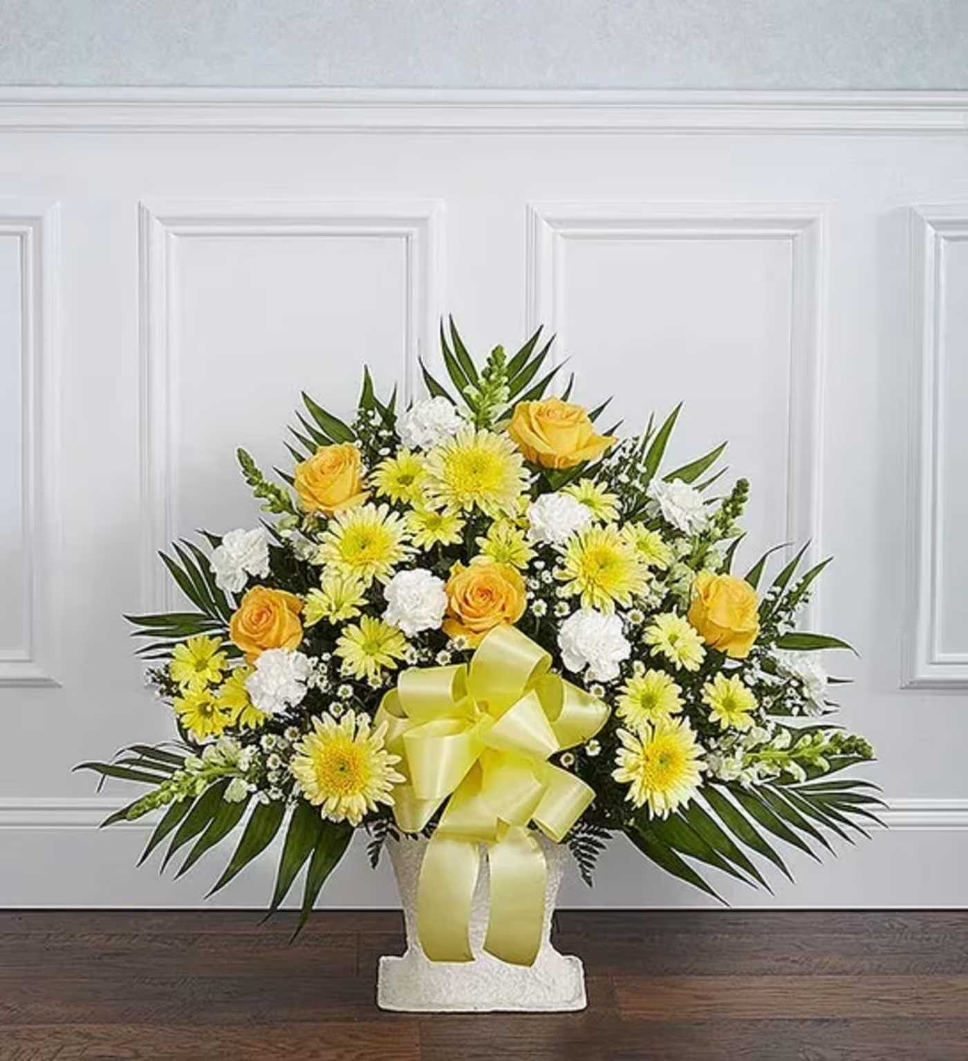 Heartfelt Tribute™ Yellow Floor Basket Arrangement - Sometimes a small ray of hope is just what is needed to get through the difficult days following the loss of a loved one. Our elegant floor basket arrangement in sunny hues, handcrafted by our caring florists with warm yellow and white blooms, is a tasteful gesture perfectly suited for the funeral home or memorial services.  Floor basket arrangement of yellow roses, cremones, carnations, and daisy poms; white snapdragons; casino; accented with soft, lush greenery Large arrangement measures approximately 36&quot;H x 38&quot;L Medium arrangement measures approximately 34&quot;H x 32&quot;L Small arrangement measures approximately 32&quot;H x 30&quot;L Appropriate for the funeral home Our florists use only the freshest flowers available, so colors and varieties may vary