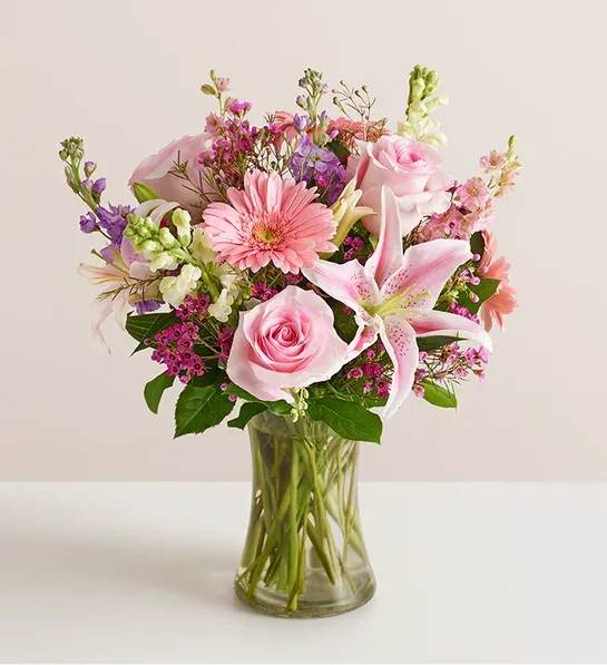 Always On My Mind™ Flower Bouquet - When it comes to letting someone know they’re always on your mind, think pink and lavender. We’ve hand-gathered a romantic mix of pink and purple blooms to create a gorgeous, garden-inspired bouquet. Designed by expert florist Breanna Cartwright of Modesto, CA, it’s a sweet and romantic surprise, whatever the reason.  All-around arrangement with pink roses, Oriental lilies, Gerbera daisies and larkspur; white snapdragons, lavender stock and purple waxflower; accented with assorted greenery Artistically designed in a clear glass gathering vase; measures 8&quot;H Premium arrangement measures approximately 20&quot;H x 16&quot;W Deluxe arrangement measures approximately 19&quot;H x 15&quot;W Standard arrangement measures approximately 18&quot;H x 14&quot;W Our florists hand-design each arrangement, so colors, varieties and container may vary due to local availability To ensure lasting beauty, Oriental lilies may arrive in bud form and will fully bloom over the next few days