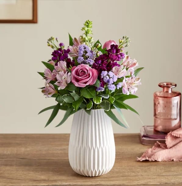 Lavender Expressions - Send a sweet, thoughtful expression with our everyday bouquet. Hand designed by our florists, this garden-inspired gathering features soothing lavender and purple, along with accents of cascading greenery. It’s arranged in our keepsake White Modern Vase, with a tapered design and matte finish that complements the beauty of every bloom.  Product Details:  All-around arrangement with lavender roses, Peruvian lilies (alstroemeria) and statice, purple larkspur and stock; accented with feather willow eucalyptus and assorted greenery Artistically designed in our Modern White Vase, with a tapered design and a matte finish, for a contemporary look that also has a softness to it, to complement everyday arrangements; measures 8&quot;H x 5.35&quot;L x 5.35&quot;W Large arrangement measures approximately 20&quot;H x 16&quot;W Medium arrangement measures approximately 19&quot;H x 15&quot;W Small arrangement measures approximately 18&quot;H x 14&quot;W Our florists select the freshest flowers available, so colors and varieties may vary due to local availability To ensure lasting beauty, Peruvian lilies may arrive in bud form and will fully bloom over the next few days