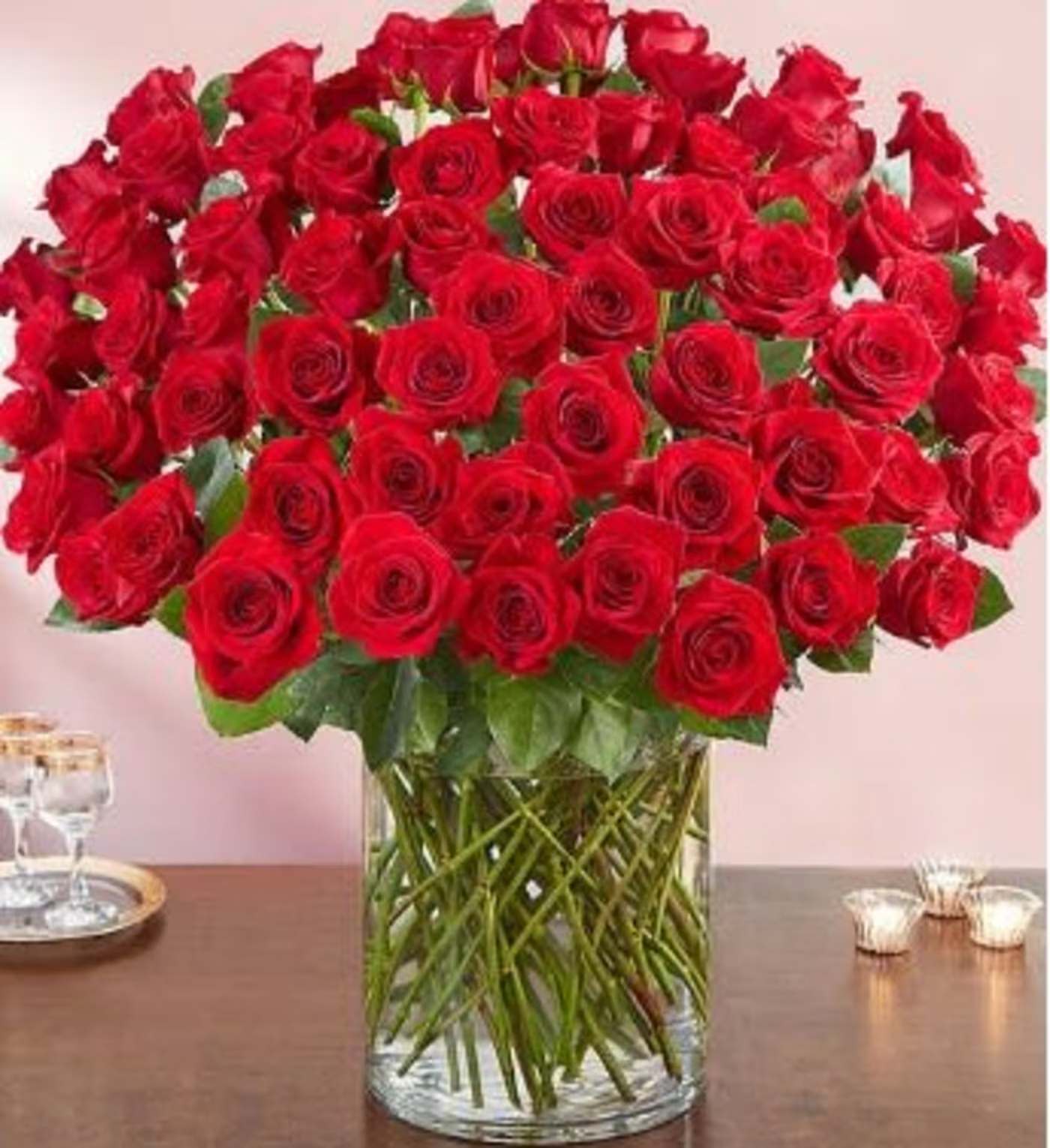 100 Premium Long Stem Red Roses - All-around arrangement with 100 premium long stem red roses; accented with assorted greenery Our florists select the freshest flowers available, so shade of rose may vary due to local availability Artistically designed in a clear glass  Arrangement measures an impressive 30&quot;H x 26&quot;L 