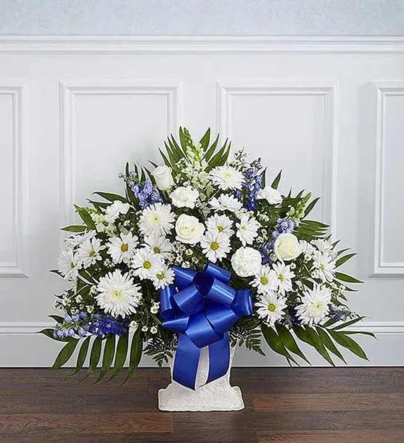 Blue &amp; White Floor Basket Arrangement - Offer the peace and tranquility that comes from classic blue and white flowers. Our elegant floor basket arrangement, handcrafted by our caring florists with pristine white and blue blooms, is a tasteful gesture perfectly suited for the funeral home or memorial services. Floor basket arrangement of blue delphinium; white roses, snapdragons, cremones, carnations. Large arrangement measures approximately 36&quot;H x 42&quot;L Medium arrangement measures approximately 34&quot;H x 40&quot;L Small arrangement measures approximately 32&quot;H x 36&quot;L Appropriate for the funeral home Our florists use only the freshest flowers available, so colors and varieties may vary 