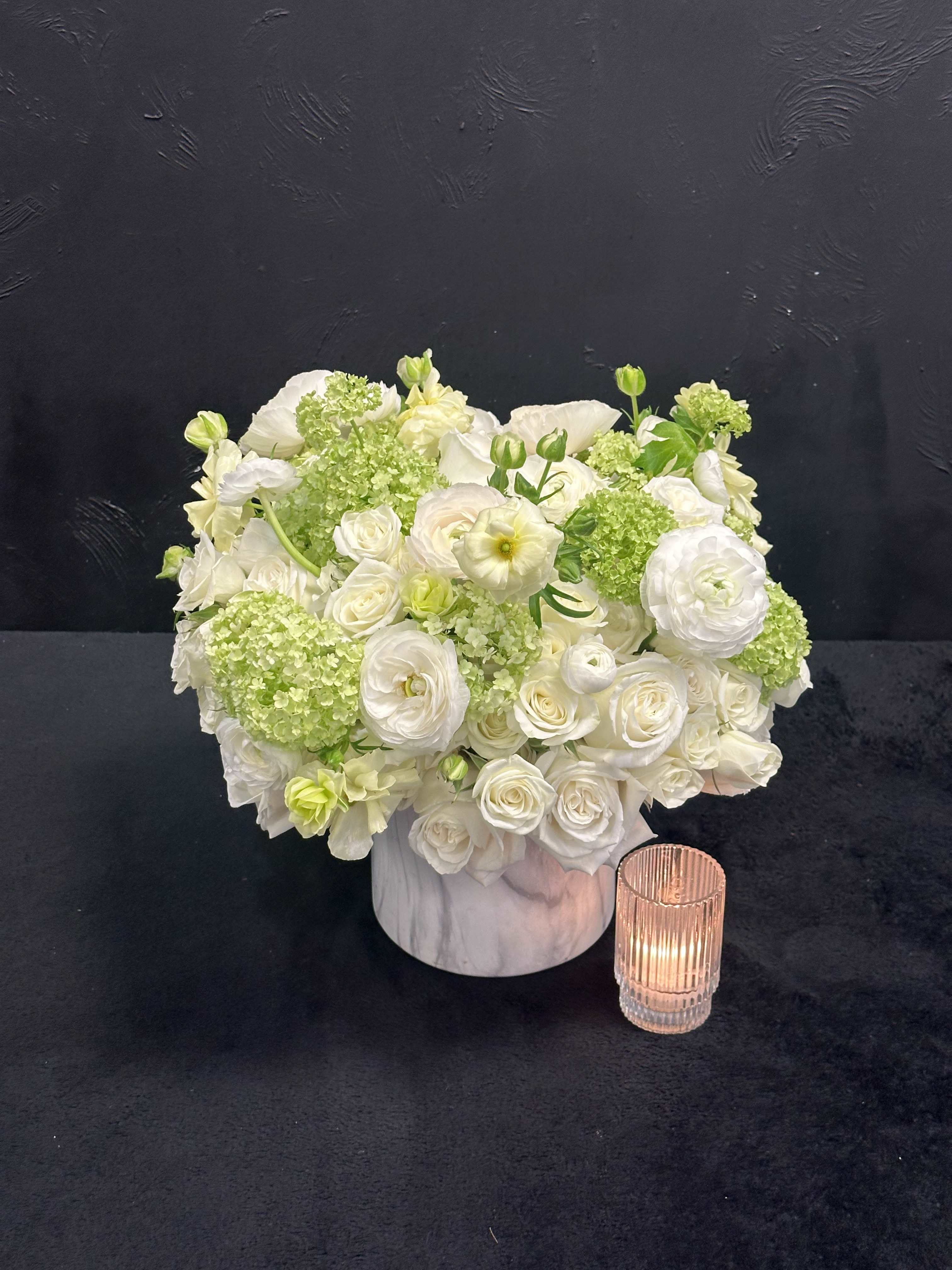 Tranquil Meadows - Tranquil Meadows arrangement combines the timeless elegance of white roses, spray roses, ranunculus and the delicate beauty of viburnum in a sleek white vase.   