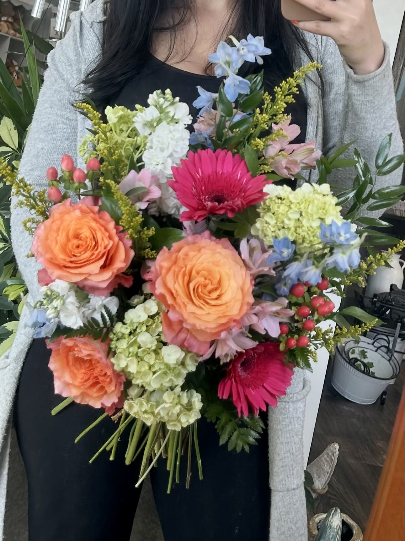 Free Spirit - Cut Bouquet - No Vase - Loose cut bouquet with free spirit roses, arcade pink gerbera daisy, light blue delphinium, pink prima donna alstroemeria, white stock, pink hypericum berries, mini green hydrangea, yellow solidago aster and assorted greenery. **NO VASE**