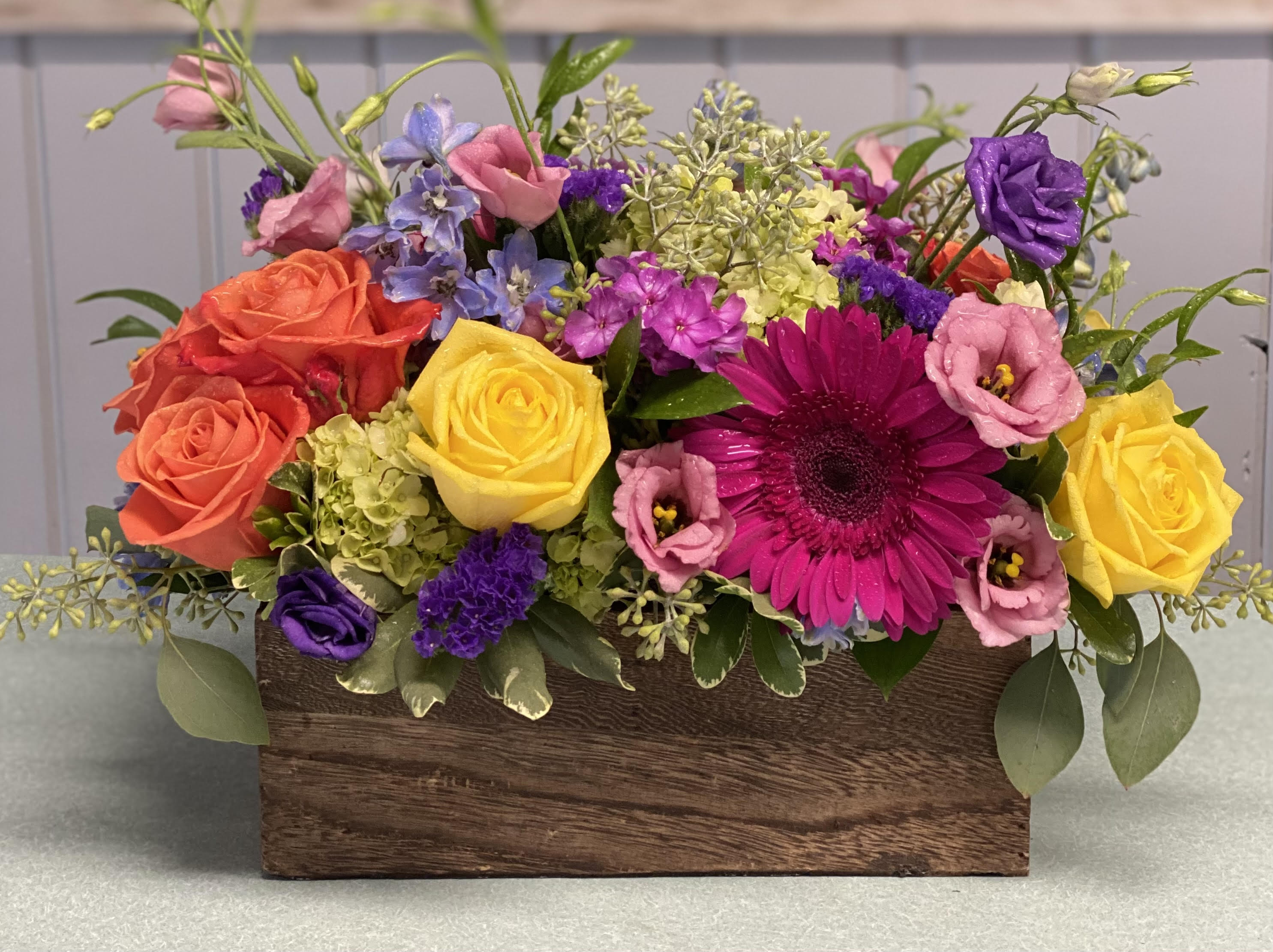 Groovy Garden Groovy Garden - Keep things fun with this jewel toned flower box! Gerbera Daisy, roses, hydrangea and lisianthus in a wooden garden box give this arrangement its bright colors and textures to create a beautiful centerpiece or gift.