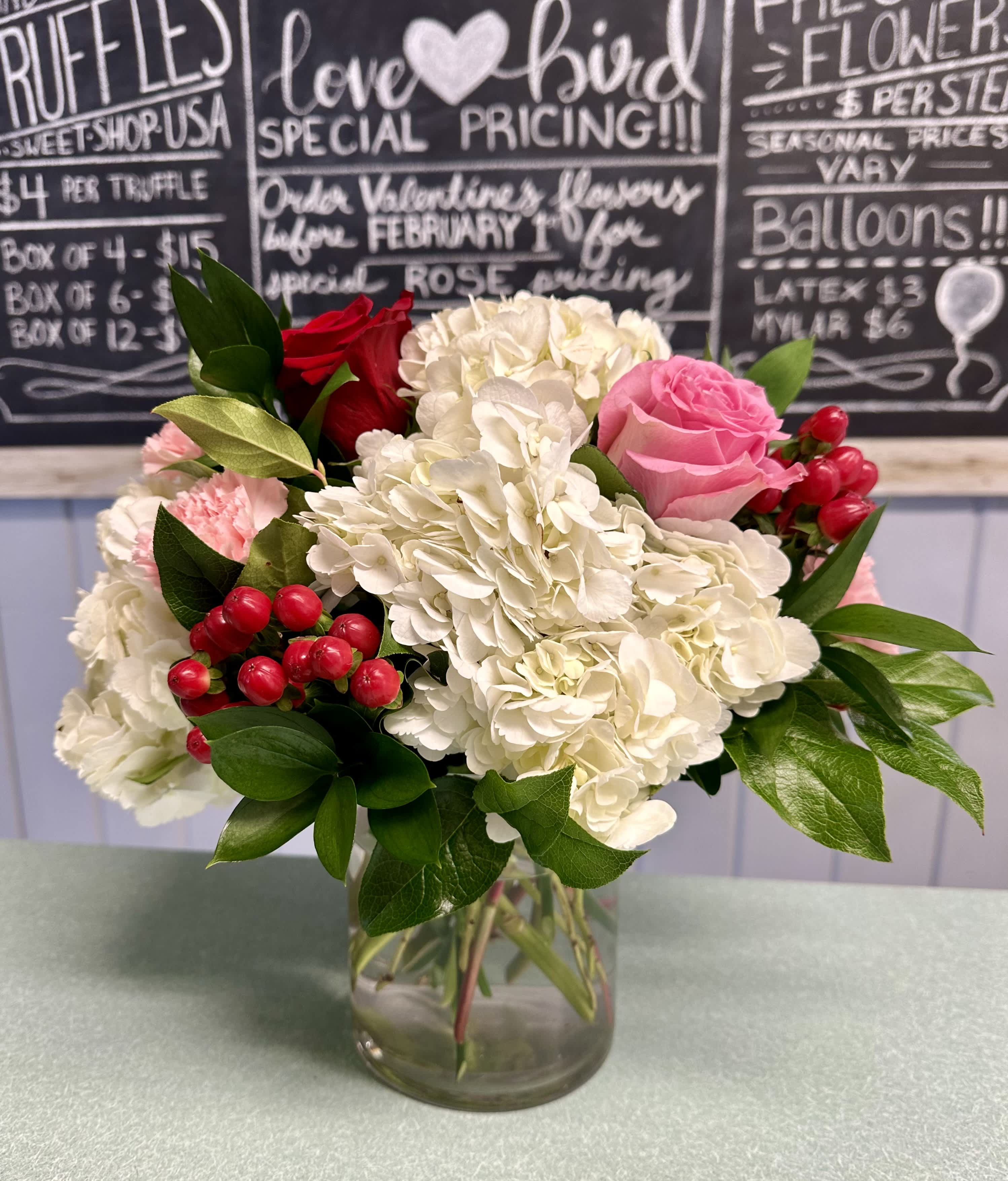 Berry Sweet Berry Sweet - White premium hydrangea, pink sweet unique roses, red freedom roses, pink carnations, red hypericum berries, assorted greenery in a 5'' clear glass cylinder vase