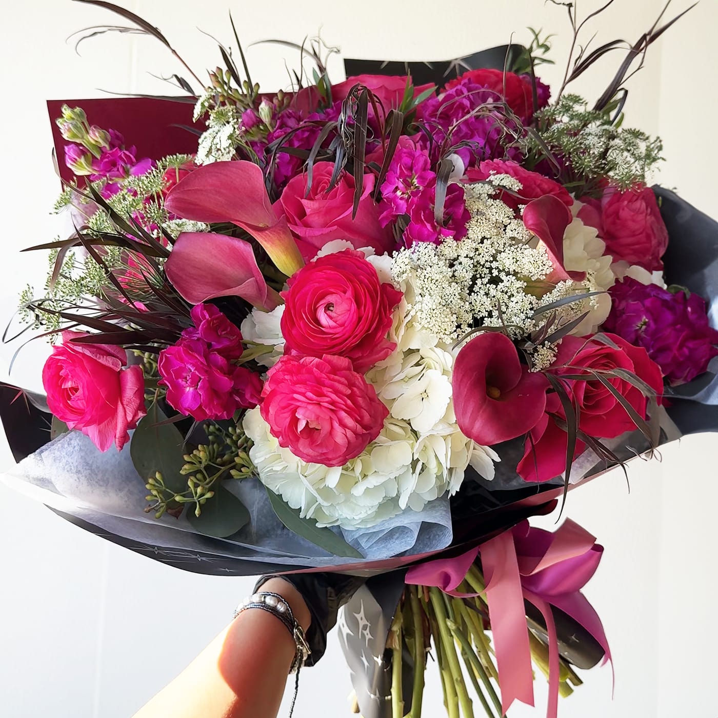 TULÚM - TULÚM - Mix Bouquet - hot pink flowers, roses, hydrangeas, ranunculus, stock, callas, eucalyptus seeded, queen Anns lace. This is just a bouquet so no vase is included.