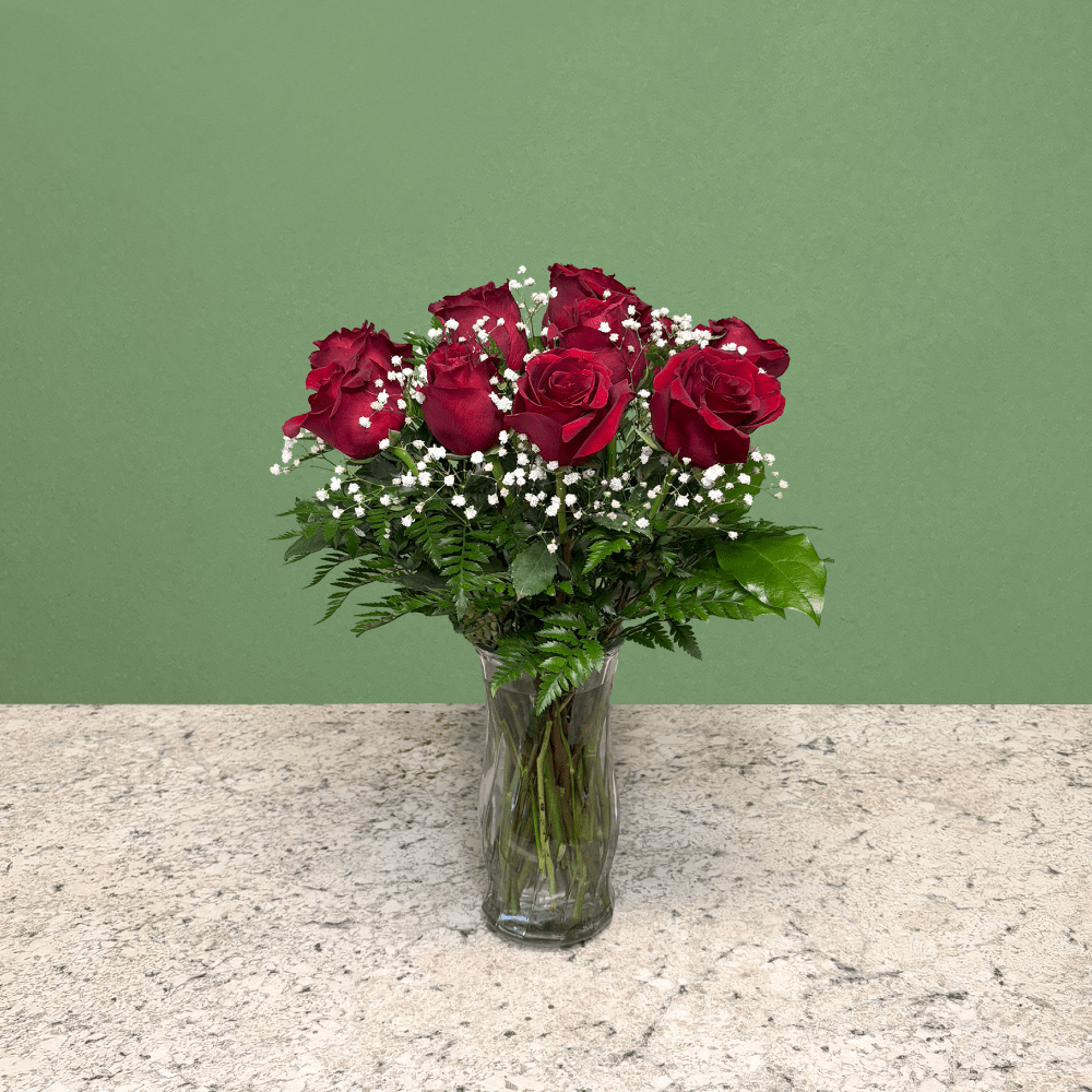 Classic Red Roses - Mixed Arrangement - A timeless expression of love and admiration. Featuring premium red roses, complemented by delicate Baby's Breath and accented with fresh leather ferns and lemon leaf. Presented in a clear glass vase.  In traditional rose arrangements, Baby’s Breath is used to add a light, airy texture that enhances the roses without overpowering them. Its delicate white blooms create contrast and volume, making the arrangement look fuller and more elegant.  Perfect for celebrating Valentine’s Day, anniversaries, and conveying heartfelt sentiments to someone special.  Stem Length: Medium (35-45 CM)  Arrives In: Clear glass vase  Orientation: Any-Sided  Approximate Dimensions (Standard / 1 Dozen): 13&quot; Tall 11&quot; Wide 8.75&quot; Vase Height  Approximate Dimensions (Deluxe / 2 Dozen) 14&quot; Tall 12&quot; Wide 8.75&quot; Vase Height  Approximate Dimensions (Premium / 3 Dozen) 18&quot; Tall 15&quot; Wide 11.75&quot; Vase Height