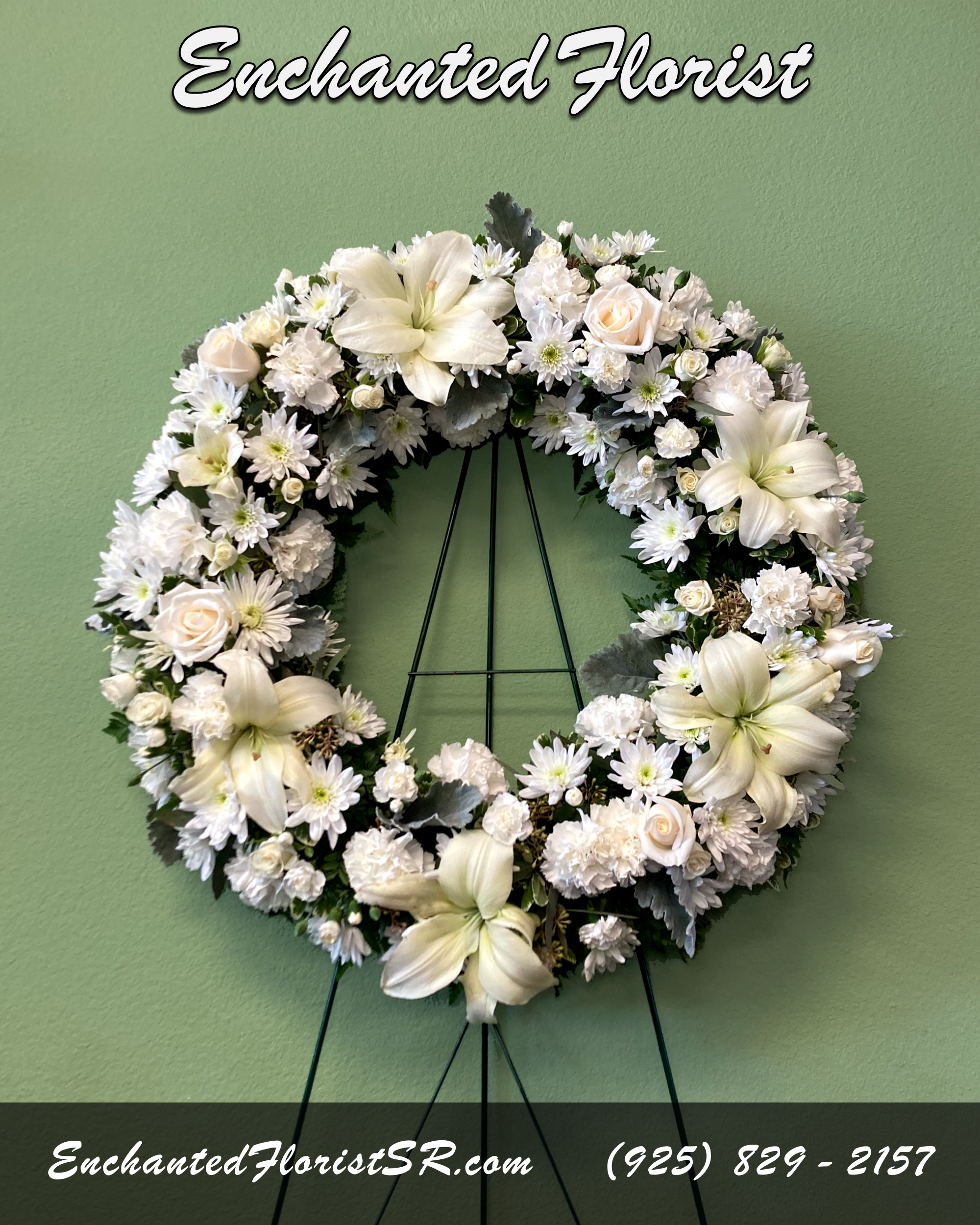 Serenity - Standing Wreath - A tranquil standing wreath of flowers that arrives delivered on an easel, showcasing a fragrant ring of pure white flowers, featuring roses, astatic lilies, carnations, spray roses and chrysanthemums. Accented with verdant leather fern, seeded eucalyptus, 'Dusty Miller' and freshly cut pittosporum.  Arrives In: Wooden easel  Orientation: One-Sided  Approximate Dimensions: Height: 24&quot; Width: 24&quot;