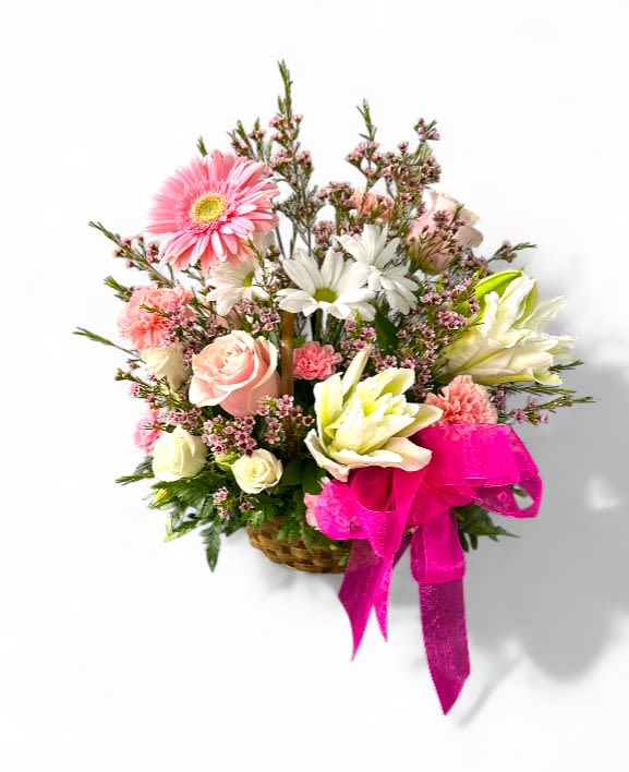 Premier Romantic Basket Premier Romantic Basket - This delightful arrangement features a variety of lovely pink and white flowers, including roses, lilies, daisies, and carnations, nestled within a woven basket. A vibrant pink ribbon adds a touch of elegance and festivity to the presentation. This thoughtful gift is sure to bring joy and cheer to the recipient. The basket's soft pink and white color palette makes it suitable for a variety of occasions. Its attractive traditional design and fresh appearance will make it a wonderful present for any celebration or to express sympathy. The basket is a thoughtful expression of affection and care.