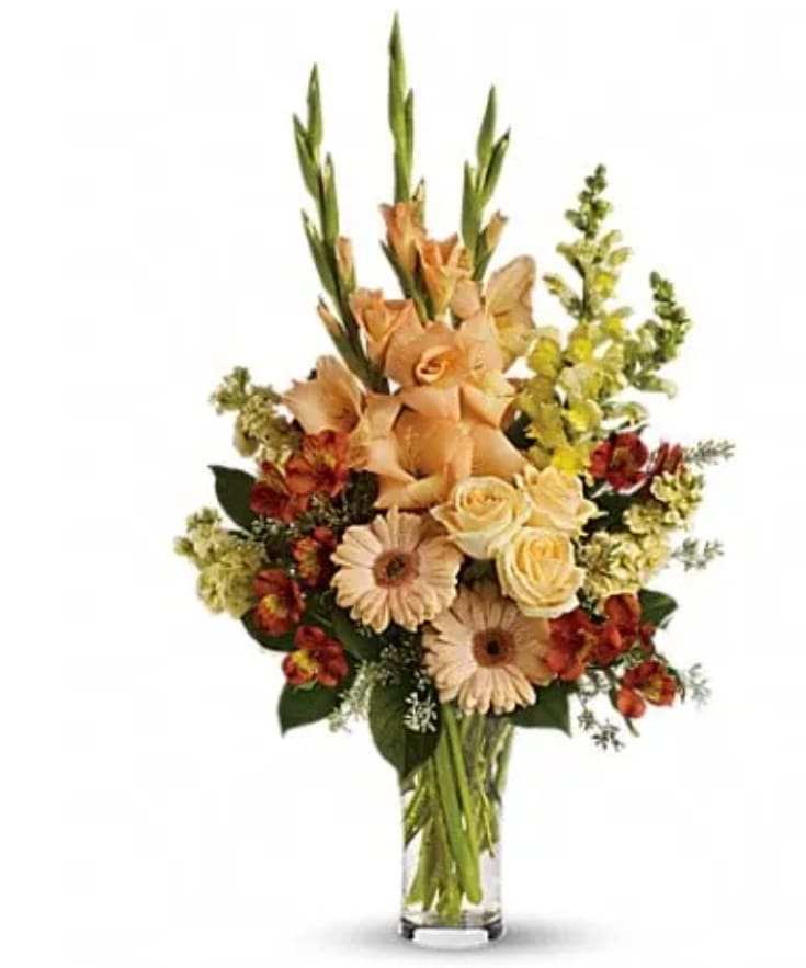 Summer's Light Bouquet Summer's Light Bouquet - Express your condolences in tasteful shades of color with peach, orange and yellow flowers in a stylish trumpet vase. For the service or the home, it is an elegant choice. The stunning bouquet includes peach roses, peach gerberas, orange alstroemeria, peach gladioli, yellow snapdragons and yellow stock, accented with assorted greenery. Delivered in a glass trumpet vase.