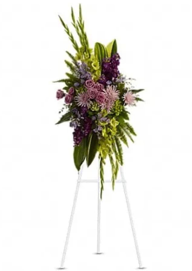 The Endless Sky Spray - Lavender blooms and lush velvet greenery evoke a celebration of a life well lived. A lovely mix of flowers such as lavender roses, chrysanthemums, statice and asters are beautifully complemented by glossy green aspidistra leaves, fern and fragrant eucalyptus.