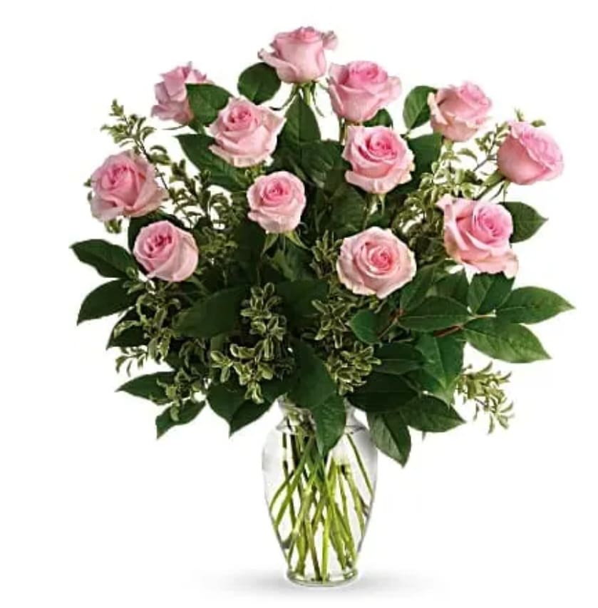 Say Something Sweet Bouquet - Say it sweeter with this feminine bouquet of a dozen ballet pink roses and lush greens in a graceful glass vase. 12 pink roses are arranged with pitta negra and lemon leaf. Delivered in a clear glass vase.