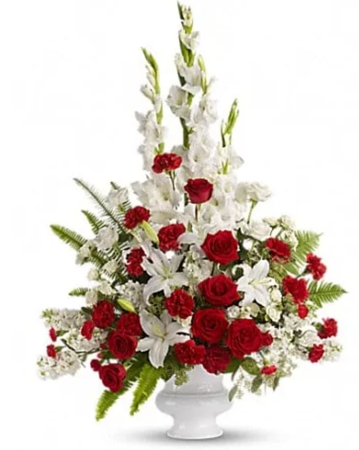 Memories to Treasure - For the sweet spirits who touch our lives, a classic pairing of red and white that is both vibrant and respectful. Beautifully contained in a white urn. A mix of fresh flowers such as red and white roses, oriental lilies, graceful gladioli, carnations and fragrant eucalyptus. Beautifully presented in a white urn.