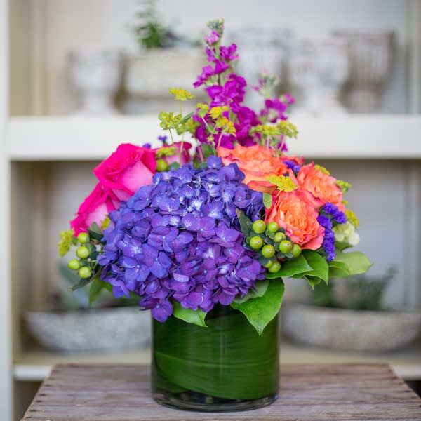 Violet Hues By Kokee Violet Hues By Kokee - A compact arrangement of rich hydrangea and roses.