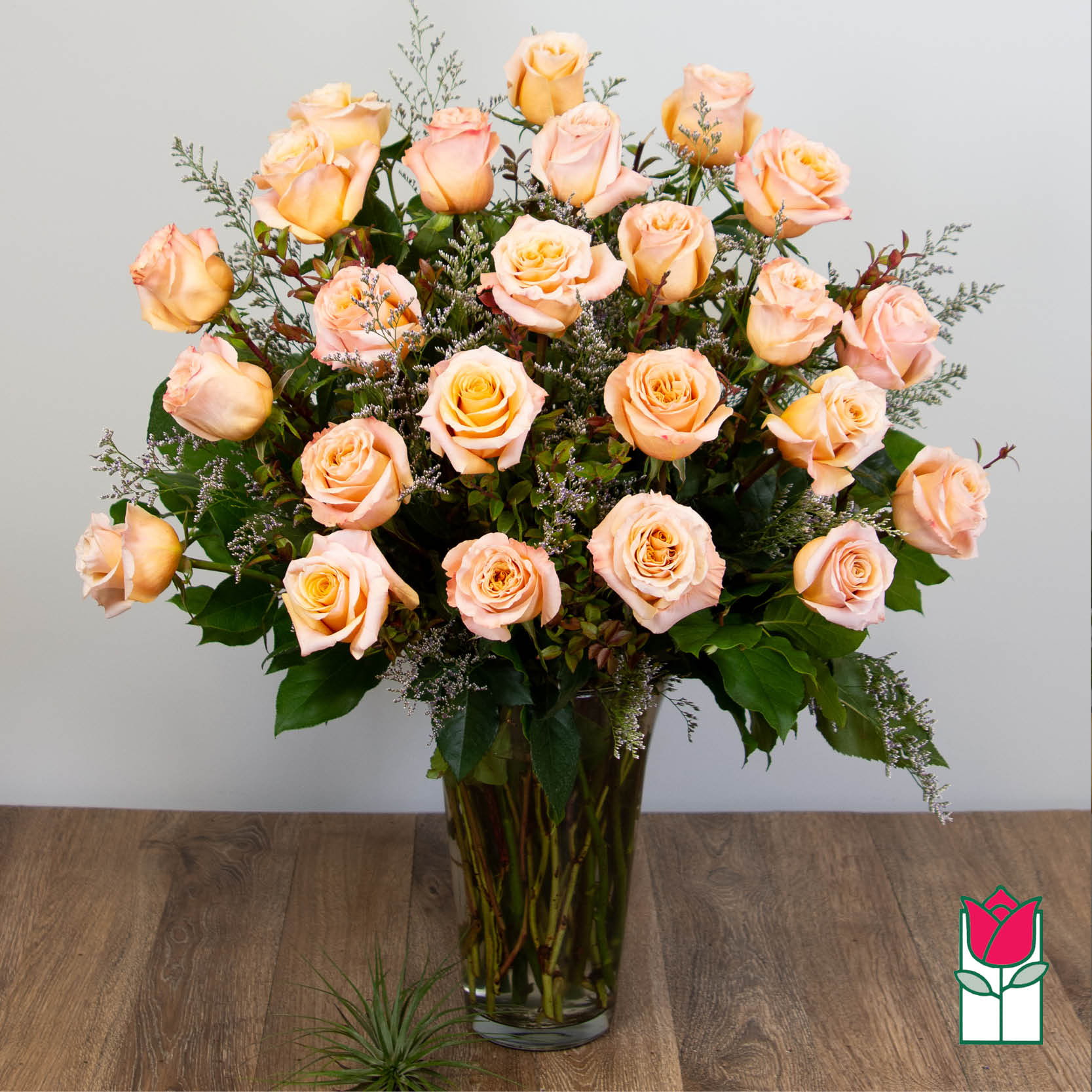 Beretania's 2 Doz. Extra Long Stem Peach Rose Bouquet - 2 Dozen Premium Extra Long Stem Peach Roses  Indulge in the timeless elegance of the Beretania Florist Premium Extra Long Stem Roses bouquet. Our exquisite bouquet features premium Ecuadorian extra-fancy roses, which are 30% larger than any other rose in the islands. Available in a classic glass vase with assorted foliage and filler flowers, this bouquet is the perfect gift for any occasion.  But our exceptional product is only half the story. At Beretania Florist, we pride ourselves on our professional and convenient delivery service. We carefully hand-deliver each bouquet to ensure it arrives at its destination in pristine condition. Our team is dedicated to providing the highest level of customer service, and we strive to exceed your expectations with every order.  And for added convenience, we offer the option to choose or upgrade the number of roses in your bouquet. Whether you prefer a classic one dozen, a stunning one and a half dozen, a grand two dozen, or an opulent three dozen, we have the perfect bouquet for you.  Trust Beretania Florist to deliver the highest quality roses and the best service in the Honolulu area.