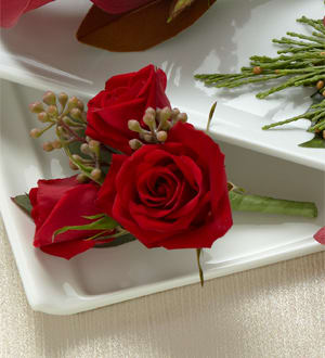 The FTD Red Spray Rose Boutonniere - The FTD&reg; Red Spray Rose Boutonniere has a fresh and modern look that will set the tone for your wedding day. Featuring two red spray rose blooms accented with seeded eucalyptus this boutonniere is the perfect choice to celebrate your day of love and commitment.