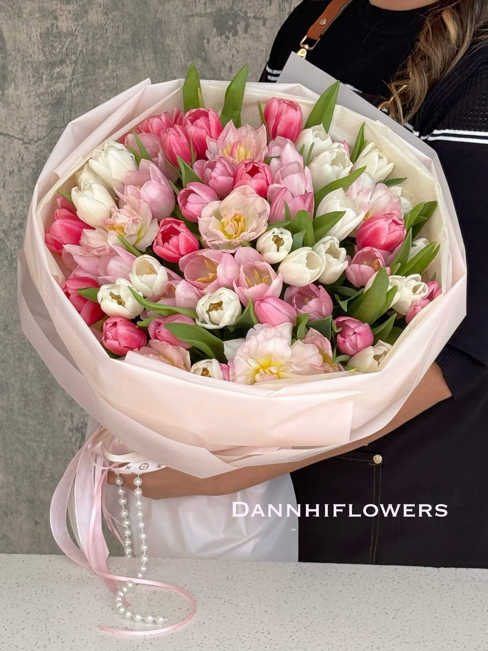 Tulip Pink Crush. - This Photo is PREMIUM size 60 tulips Standard size: 20 tulips Deluxe: 40 tulips  Pls call us if you want different tulip colors.  * All of our bouquets are wrapped with water in cellophane to keep the flowers fresh. If you need a vase, you can add it during checkout. Please let us know in the instructions if you prefer the bouquet without water.  Care Instructions: Please DO NOT remove the paper wrapping. The cellophane with water underneath acts as the vase. The next day, you can cut away the cellophane and gently hold all the flower stems with both hands inside the design paper, then place them in a vase with water. If possible, please change the water daily. 