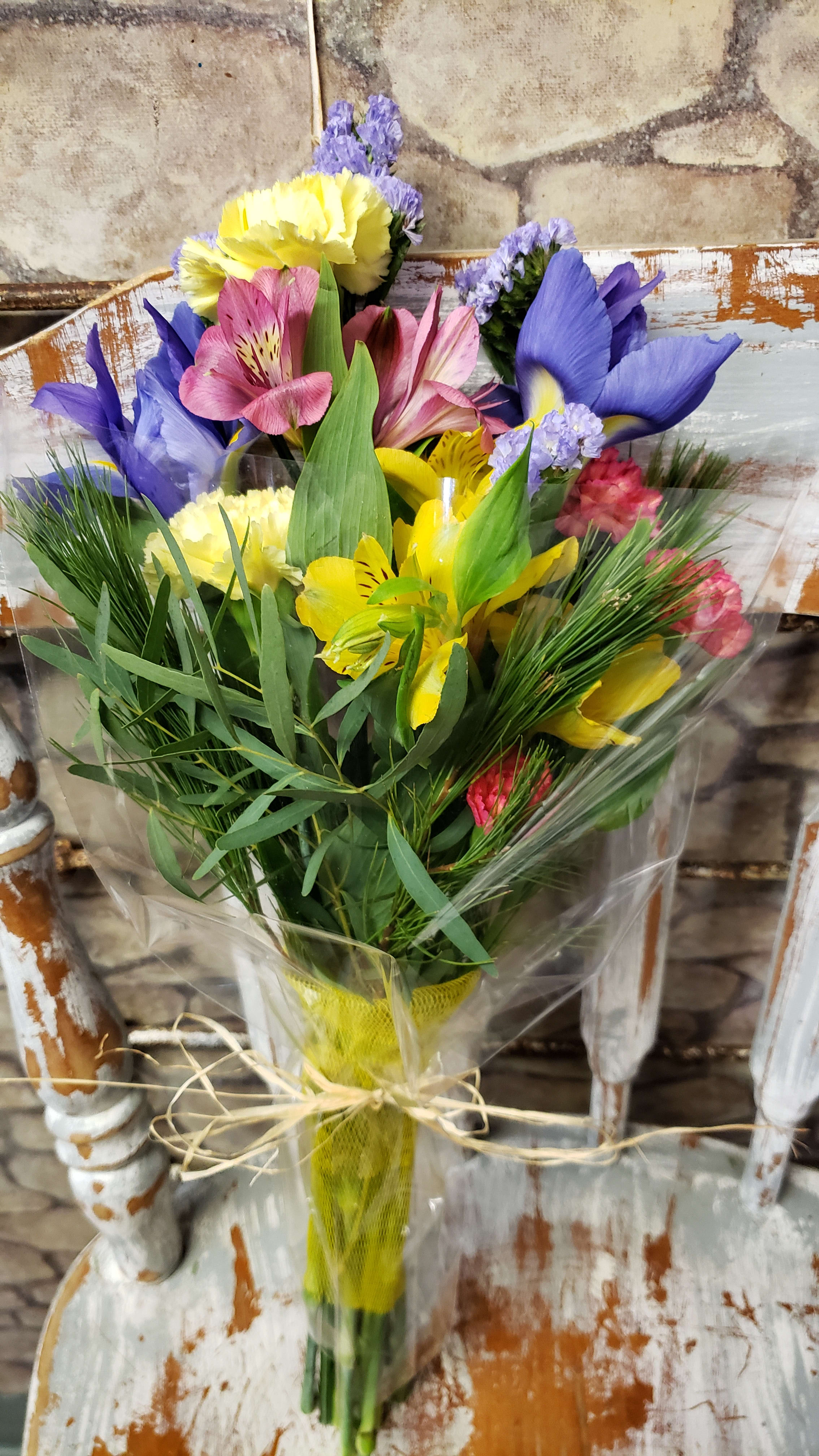 It's a Wrap It's a Wrap - THIS SAMPLE PHOTO IS JUST THAT!! IT WILL NOT MATCH THE PHOTO. The designer will gather a variety of fresh cut flowers with greens all wrapped in clear plastic or paper roll wrap.. NO Vase or design with this choice. The flowers will always vary and will NOT match as shown. Sample photo for style! We'll choose a variety of market fresh flowers in stock at time of order or delivery.