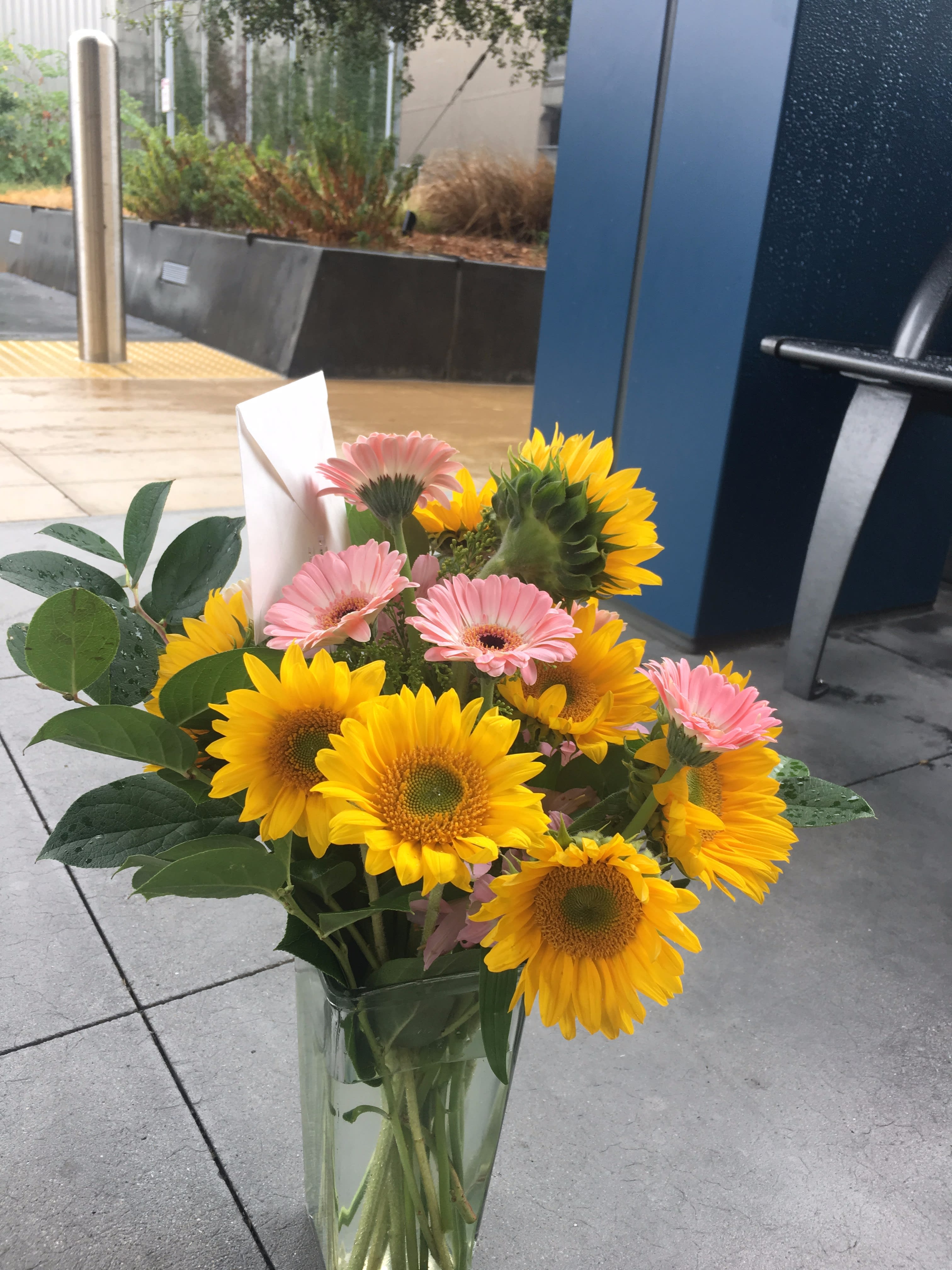 Happy Days by Seulberger's Florist - Cheerful mix of Gerbera daisies and Sunflowers.
