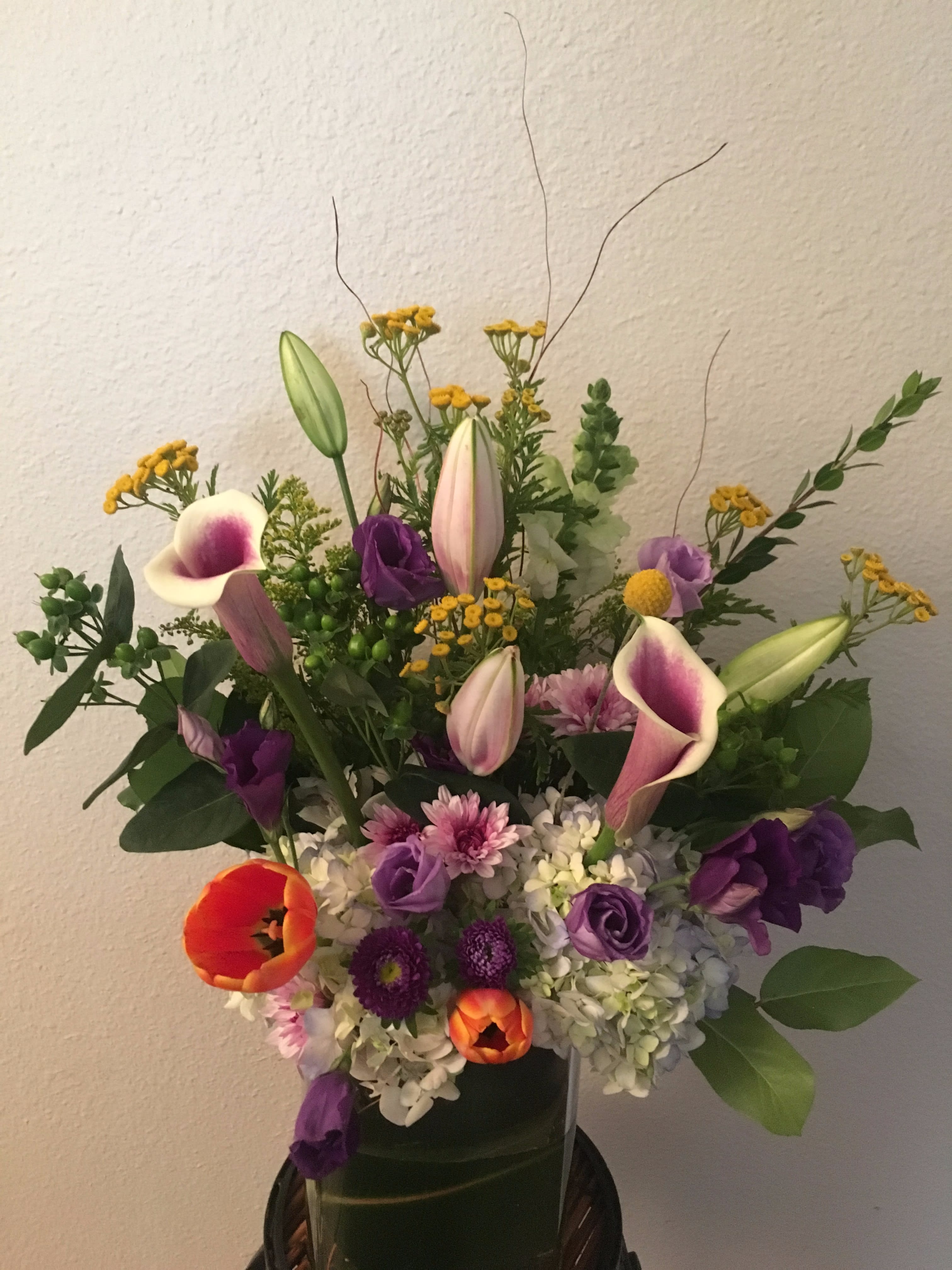Nobe Nobe - colorful spring mix of two tone cala lilies,tulips,stargazer lilies,lysianthus ,hydrengia and yellow yarrow and more...