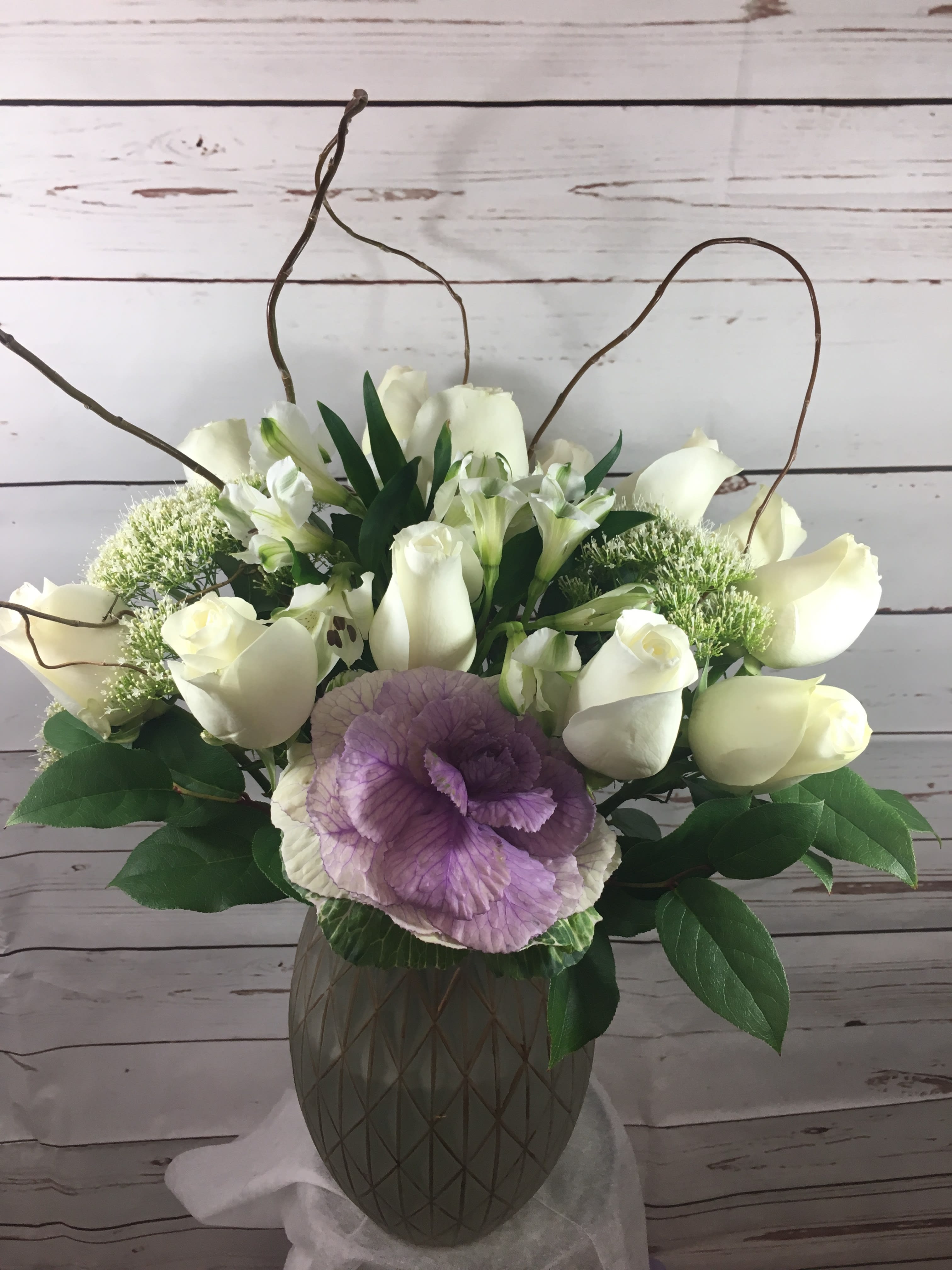 Pure Love Pure Love - As pure as it gets,a dozen of large head snow white ecuadorian roses beautifully arranged with white trichilium and soft lavender kale flower and curly willow in a nice vase to express pure love.
