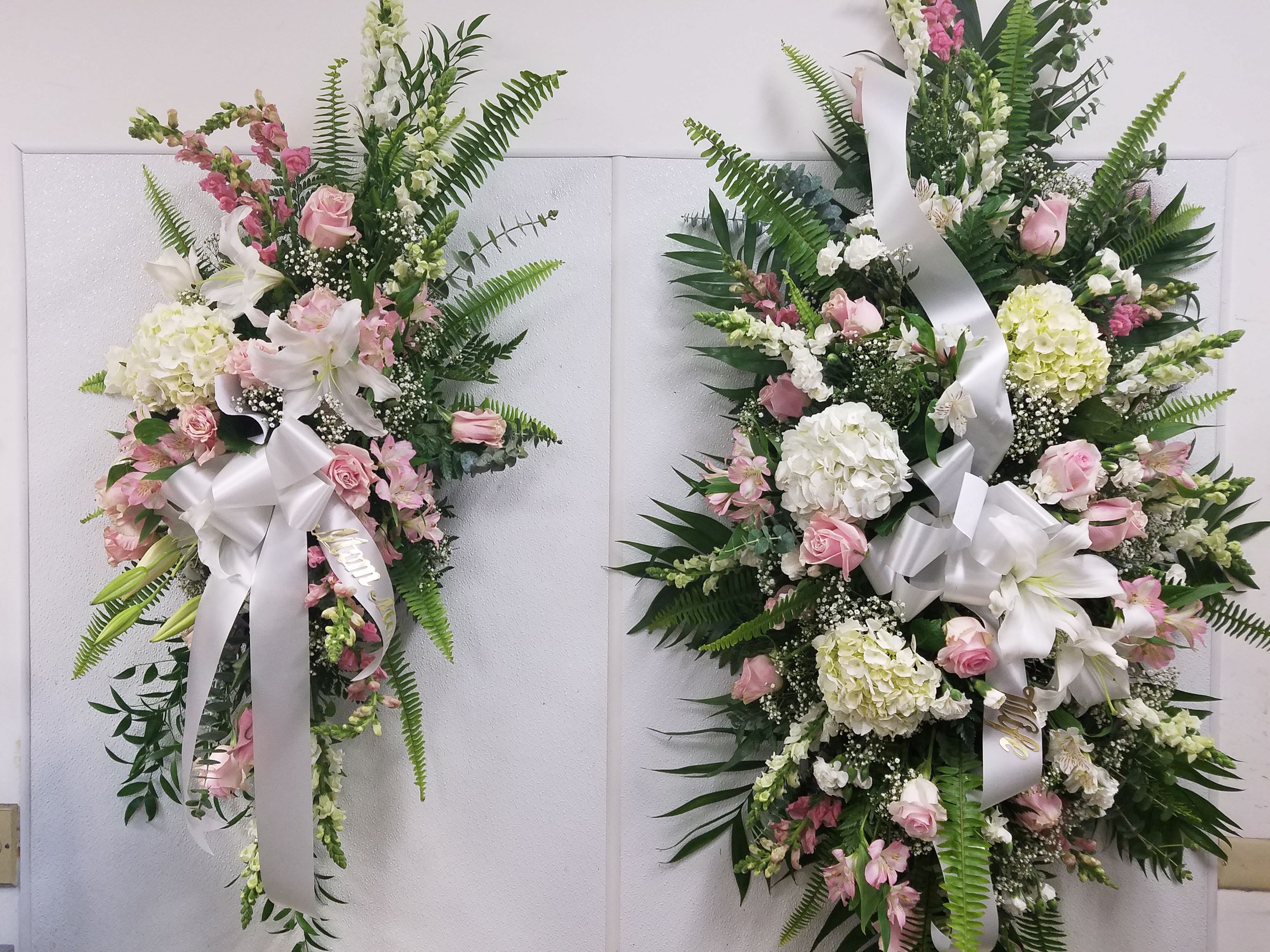 Pink and White Sympathy Package - This Pink and White Sympathy Package features a Full Casket Spray and Two Standing Sprays. Ribbon Scripts may be added at no additional cost.