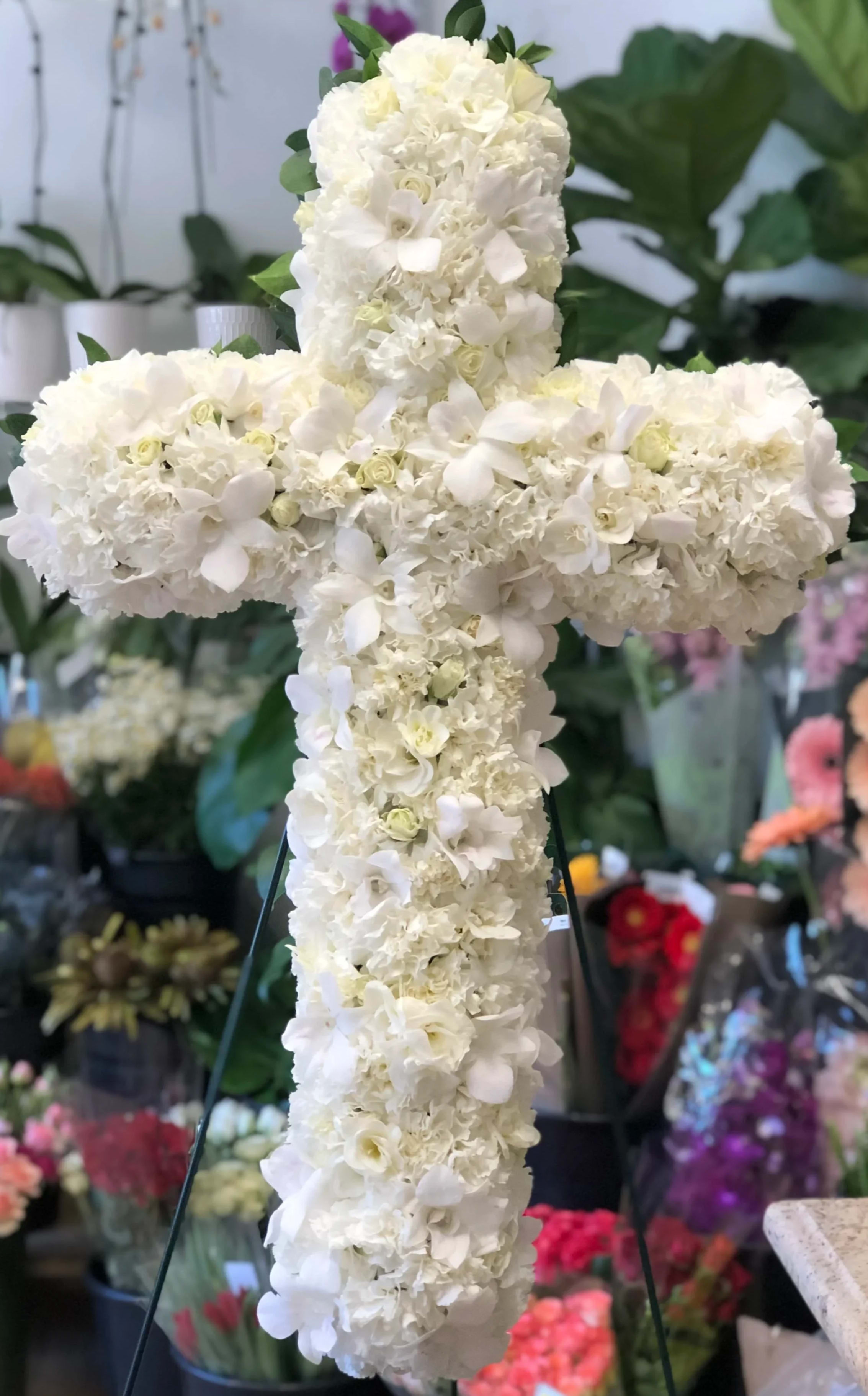 Faith Faith - Foliage includes: Carnation, Spray Rose, Freesia and Dendrobium Orchid We advise our customers to order 24-48 hours in advance of their scheduled delivery to ensure that we are able to have similar flowers and colors in the shop for their order. $250 (18 inches) as shown
