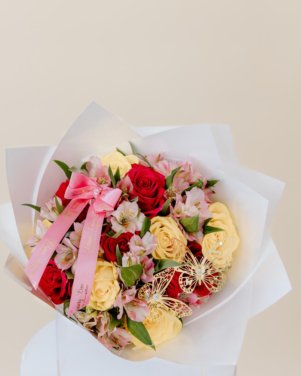 MOM Beauty mix bouquet - Nothing's sweeter than the prettiest  MOM Beauty mix bouquet  Our arrangement is a luxury mom  bouquet is a mix of hoy and yellow roses and pink alstroemeria, decorated with bow, butterfly and wrap  if you like to surprise mom and order this luxury arrangement.  Because mom deserved to get the best arrangement don't wait until last minute, arrangements will be limited.