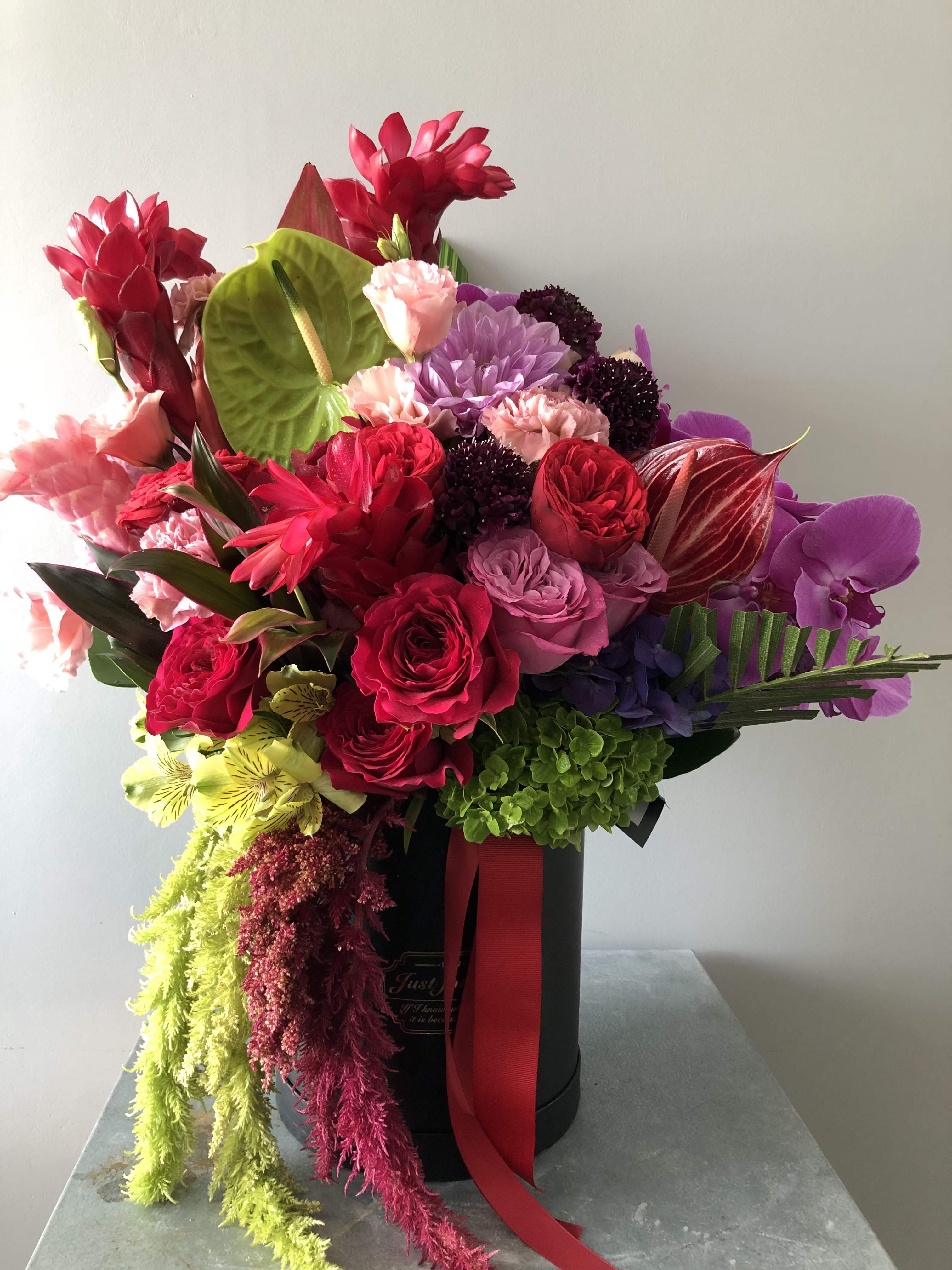Midnight Blooms - Introducing Midnight Blooms, this captivating design combines the allure of deep, velvety orchids with the striking beauty of anthuriums and the bold texture of dahlias. Lush roses and hydrangeas are nestled among rich greens, creating a perfect harmony of color and form. Midnight Blooms is perfect for upscale events, special occasions, or simply to indulge in the opulence of nature’s finest blooms.