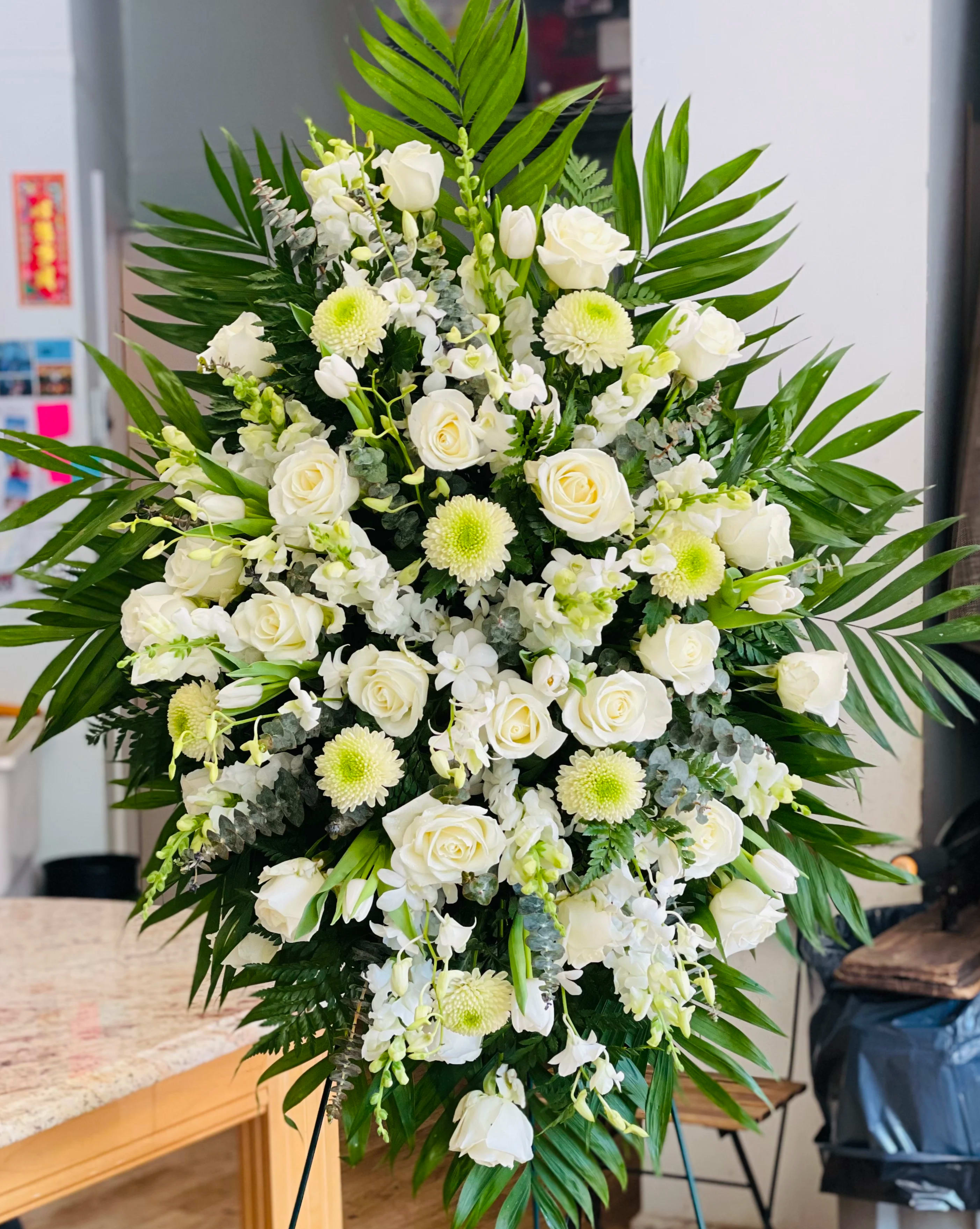Standing Spray 4 - Foliage includes: Rose, Snapdragon, Tulip, Dendrobium Orchid, Chrysanthemum and Baby Blue Eucalyptus.   We advise our customers to order 24-48 hours in advance of their scheduled delivery to ensure that we are able to have similar flowers and colors in the shop for their order.  $300 (deluxe) as shown