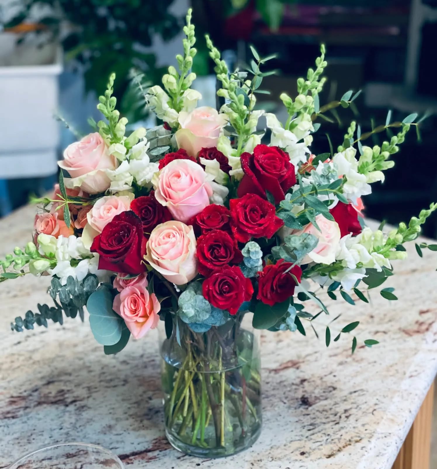 The Flower of Love The Flower of Love - This bouquet is filled with roses, spray roses, snapdragons and mix eucalyptus. We advise our customers to order 24-48 hours in advance of their scheduled delivery to ensure that we are able to have similar flowers and colors in the shop for their order. $150 (standard) as shown