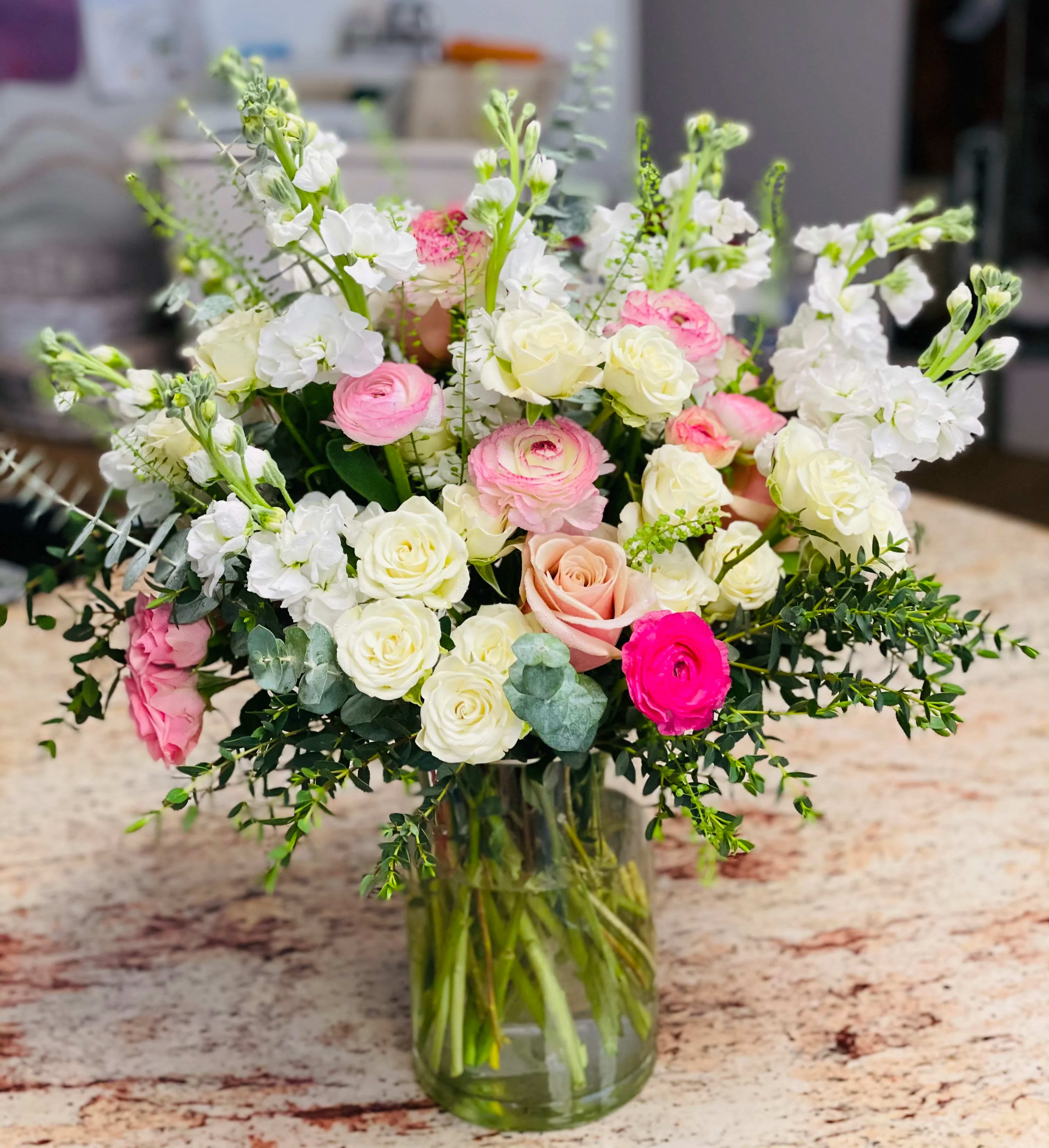You're Beautiful  - This bouquet of different shades of pinks and white is filled with spray roses, roses, stocks, ranunculus, and mix greeneries.   We advise our customers to order 24-48 hours in advance of their scheduled delivery to ensure that we are able to have similar flowers and colors in the shop for their order.  $150 (deluxe) as shown