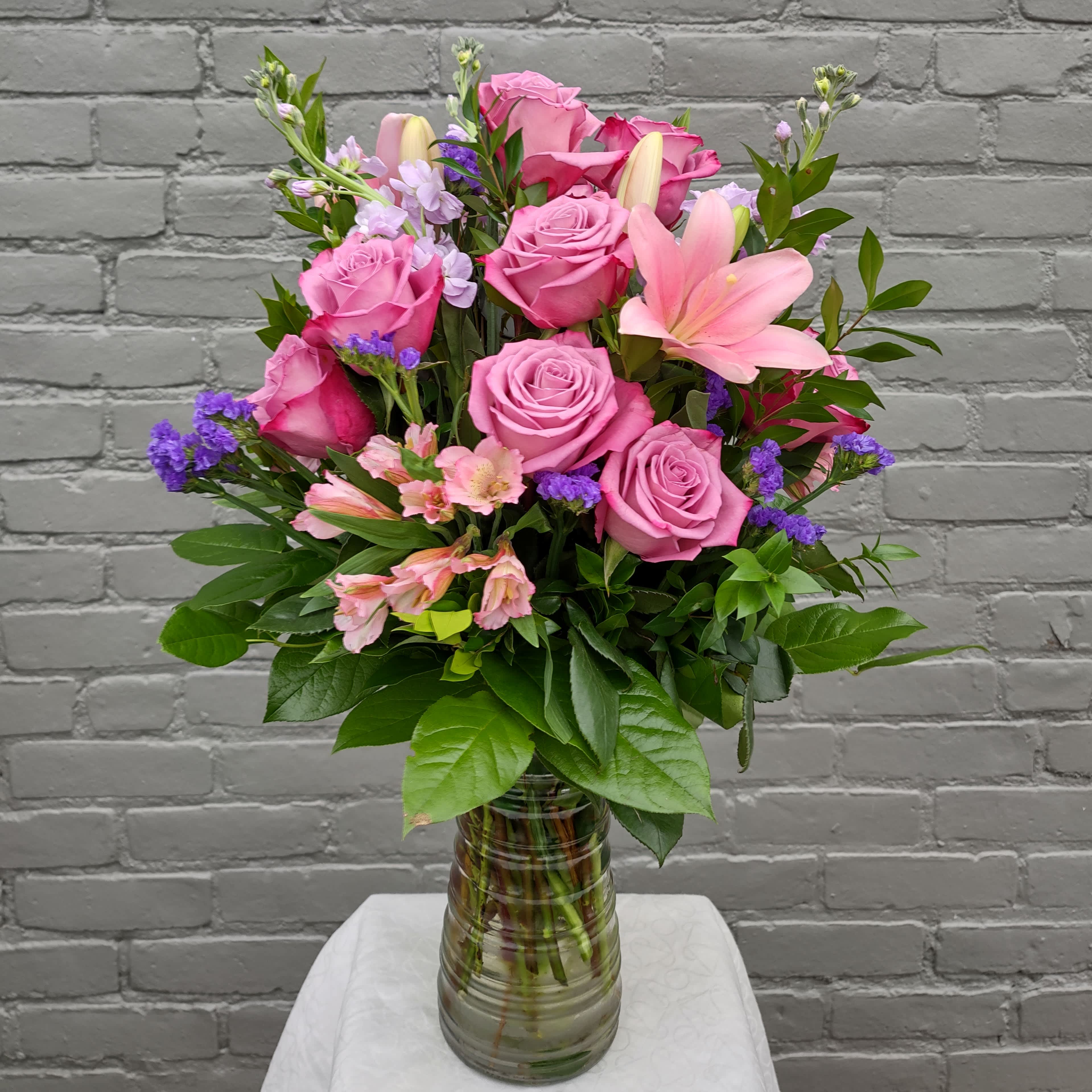 Premium Lavender Rose Bouquet Premium Lavender Rose Bouquet - One dozen lavender roses arranged with beautiful garden flowers in lavender and purple tones.