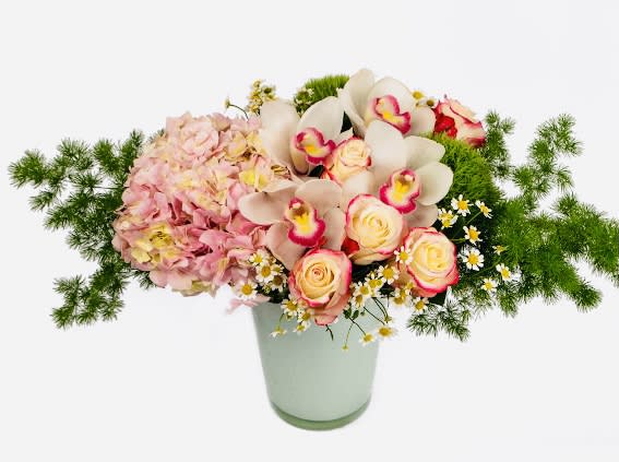 Sweet Success  - Light pink hydrangea, green dianthus, Soft pink/white cymbidium orchids, roses and more.