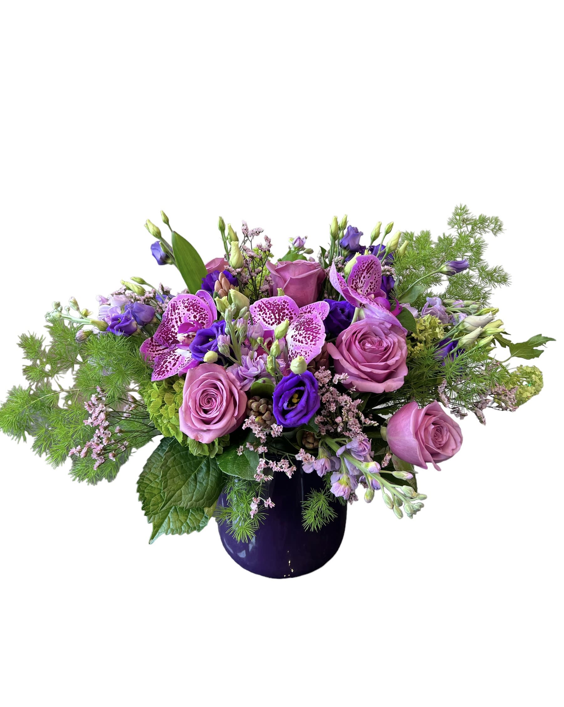 Lavender Vanda Lavender Vanda - Lavander roses, green hydrangea, hyacinths, purple stock, lisanthus, lavender vanda orchid and more designed in a purple glass vase. As shown in photo.