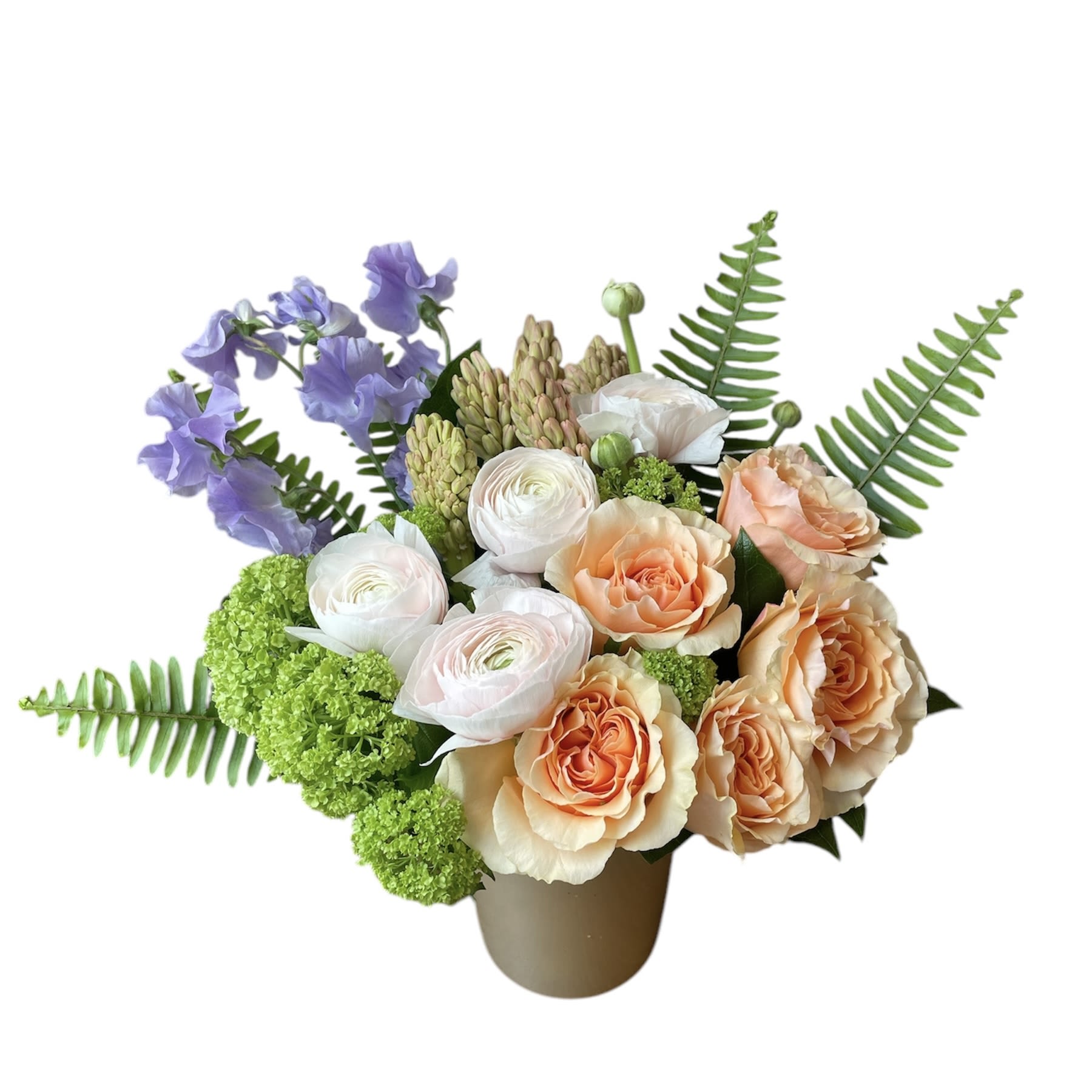 Spring Dreams Spring Dreams - Light peach roses, light pink ranunculus, viburnum, hyacinths, fern and lavender sweet pea designed in a glass vase. As shown in photo.