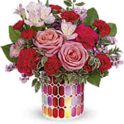 Teleflora's Charming Mosaic Bouquet Teleflora's Charming Mosaic Bouquet - Charmed, I'm sure! Sweep her off her feet with this lovely bouquet of pink blooms presented in a magnificent mosaic vase of pearlescent stained glass. Pink roses, pink alstroemeria, hot pink carnations, miniature red carnations and pink sinuata statice are arranged with pitta negra and lemon leaf. Delivered in Teleflora's Charming Mosaic Cylinder. Orientation: All-Around