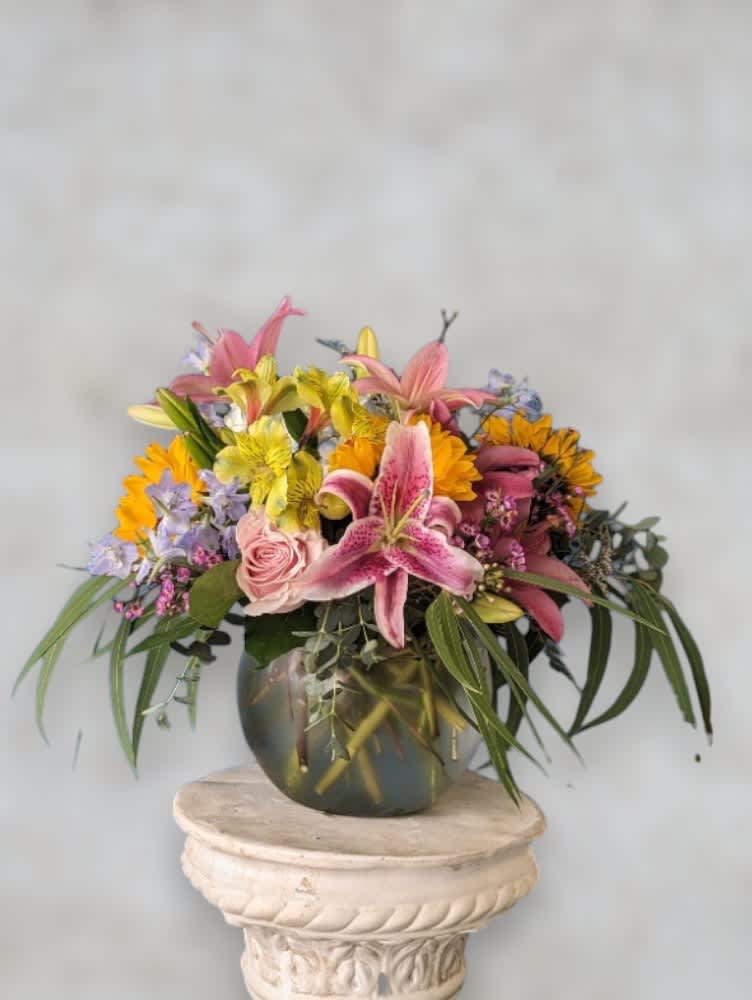 Bowl of Love by Art &amp; Flowers - Meet 'Bowl of Love' – a delightful flower arrangement presented in a charming bubble bowl. Overflowing with a harmonious blend of roses, lilies, and other exquisite blooms, this arrangement radiates warmth and affection. Perfect for expressing love, gratitude, or celebration, 'Bowl of Love' is a timeless centerpiece that brings joy to any occasion. Share your sentiments with elegance and beauty through this heartfelt creation.