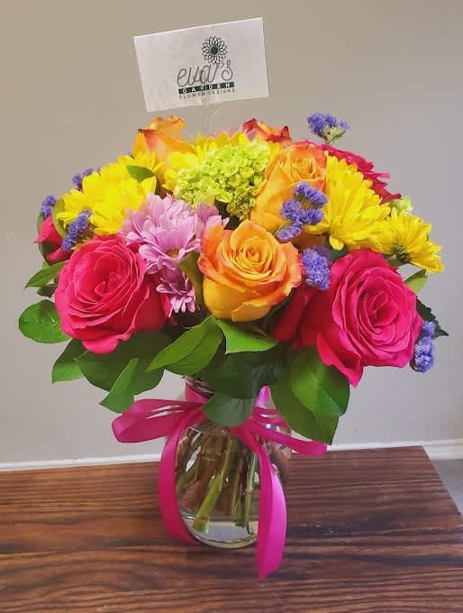She's Vibrant - Crystal vase arrangement 5 orange roses, 3 hot pink roses, 3 mini hydrangeas, and yellow daisies.