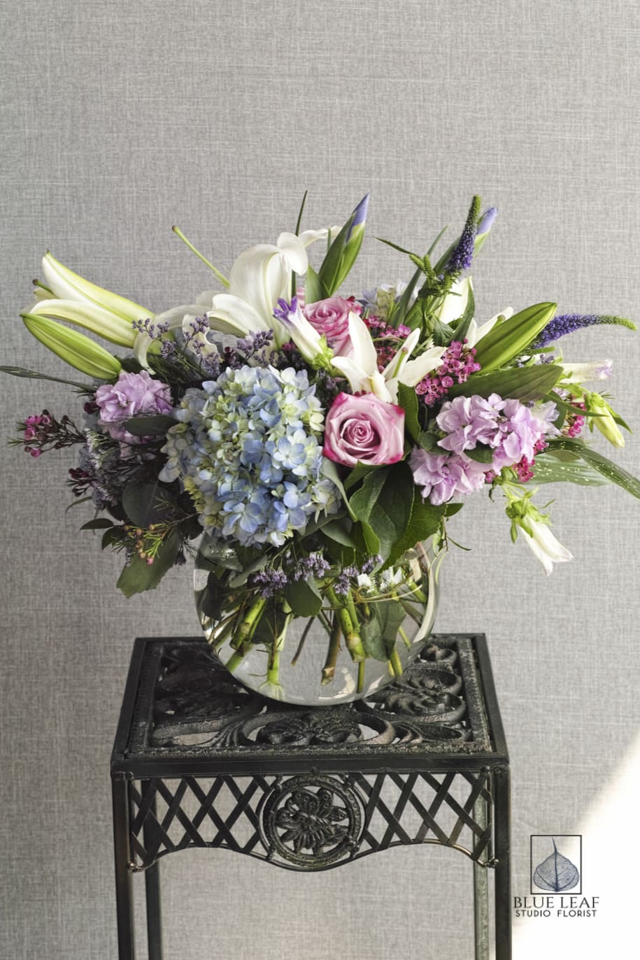 Bowl of Beauty Bowl of Beauty - A beautiful, natural design of white lilies, light blue hydrangeas, roses, and assorted fillers in a bubble bowl.